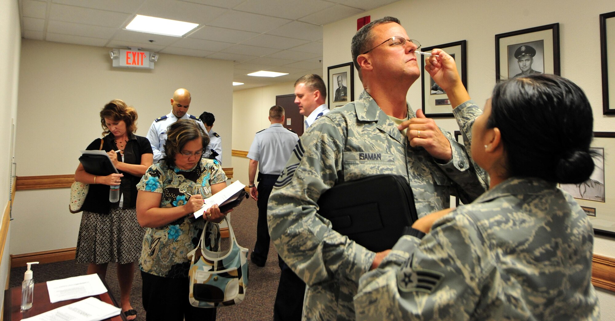 Senior Airman Crystal Whiterock, 22nd Medical Group medical technician, gives flu shots to Airmen and commanders in the Wing Headquarters building Sept. 19, 2011, McConnell Air Force Base, Kan. A yearly flu vaccine is the first and most important step in protecting against flu viruses.
(U.S. Air Force photo by Senior Airman Courtney Witt)