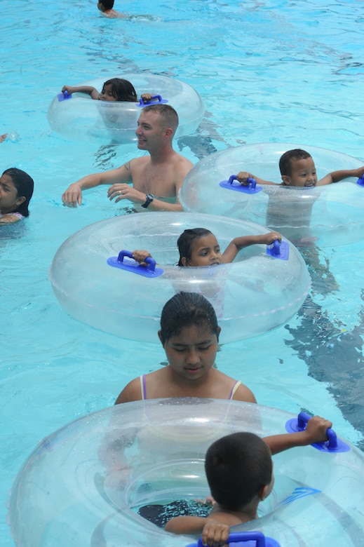 Master Sgt. Lee Markwell, Army Support Activity, cools off with children form a local orphanage Sept. 17, 2011 during their visit to Soto Can Air Base, Honduras. (U.S. Air Force photo/Tech. Sgt. Matthew McGovern)