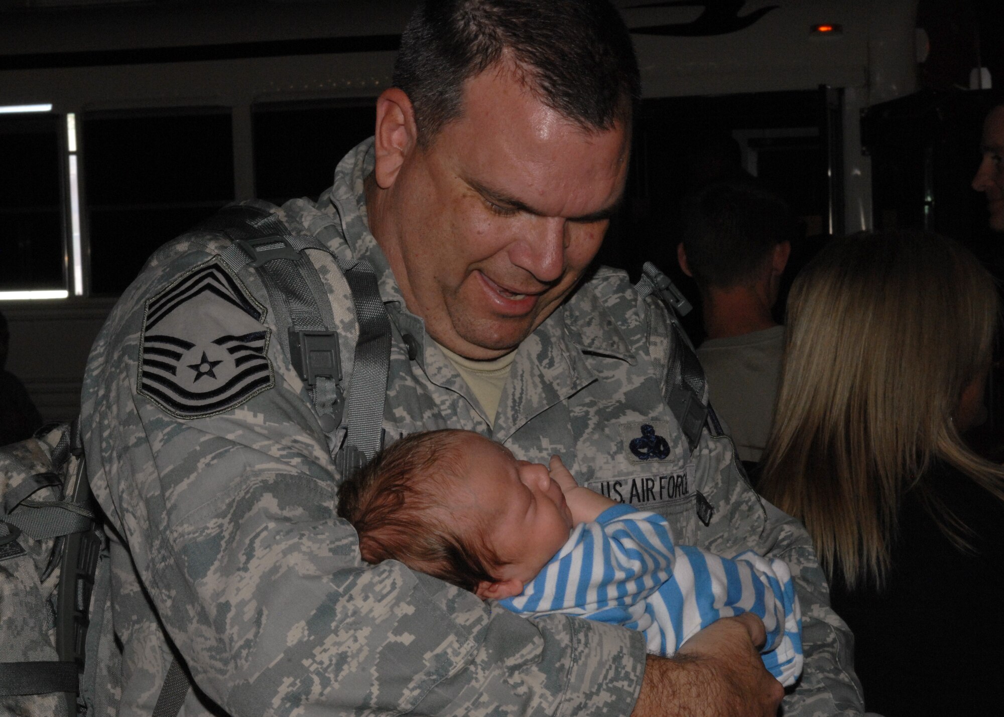DAVIS-MONTHAN AIR FORCE BASE, Ariz. – Chief Master Sgt. Michael Zielinski, 354th Aircraft Maintenance Unit, holds his grandson Isaiah for the first time here Sept. 19. Members of the 354th Fighter Squadron as well as squadron assets and members of the 355th Maintenance Group return from a 6-month deployment at Osan Air Base, Republic of Korea. (U.S. Air Force photo/Airman 1st Class Timothy D. Moore)