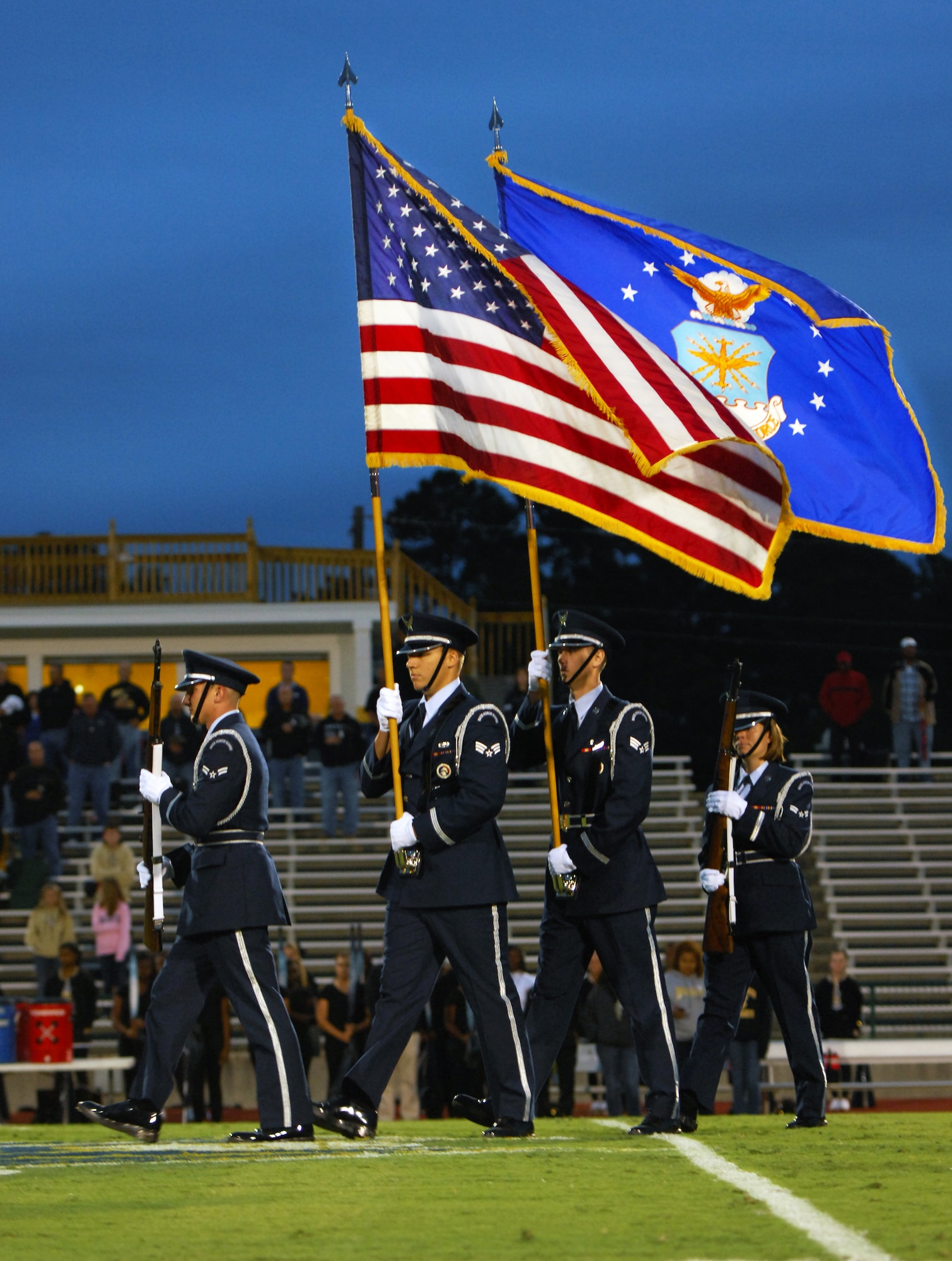 Shaw Air Force Base Honor Guard post the 'Colors' during the playing of the National Anthem during the Sumter versus North Augusta High School game at Sumter High School Football Stadium, S.C., Sept. 16, 2011. Sumter High School held a Military appreciation night whereMr. John Kennedy, 20th Force Support Squadron school liaison officer sang the National Anthem. (U.S. Air Force photo by Airman 1st Class Tabatha Duarte/Released)