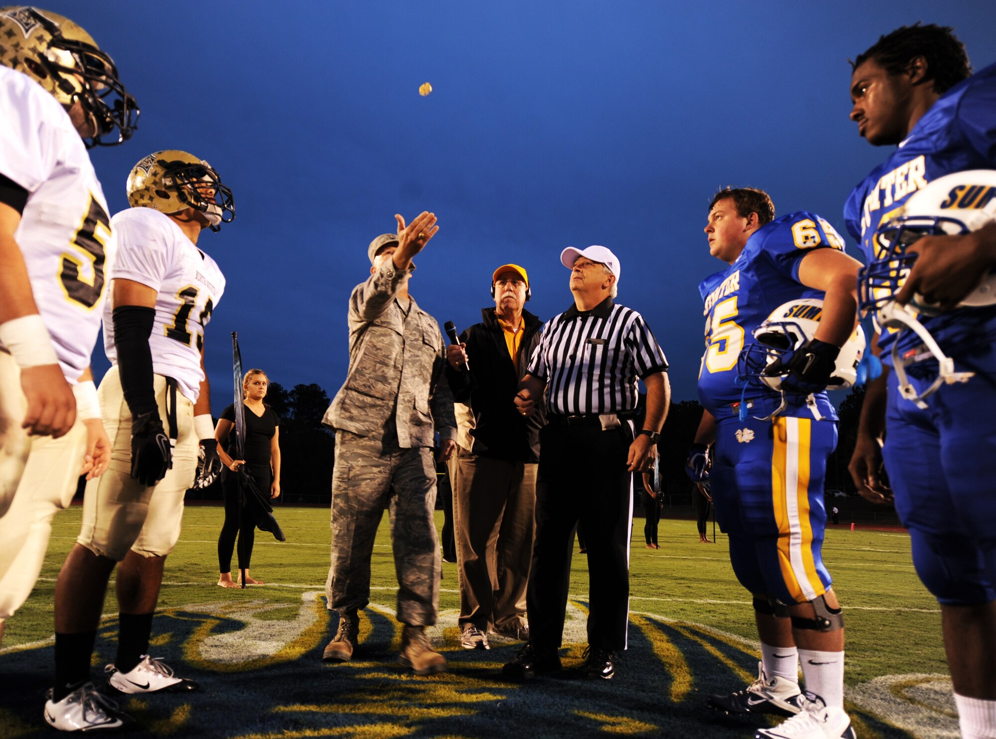 U.S. Air Force Col. Walter Fulda, 20th Mission Support Group commander, flips a coin before the Sumter versus North Augusta game at Sumter High School Football Stadium, S.C., Sept. 16, 2011. Sumter High School held a Military appreciation night where Shaw Air Force Base Honor Guard posted the 'Colors' and Mr. John Kennedy, 20th Force Support Squadron school liaison officer sang the National Anthem. (U.S. Air Force photo by Airman 1st Class Tabatha Duarte/Released)
