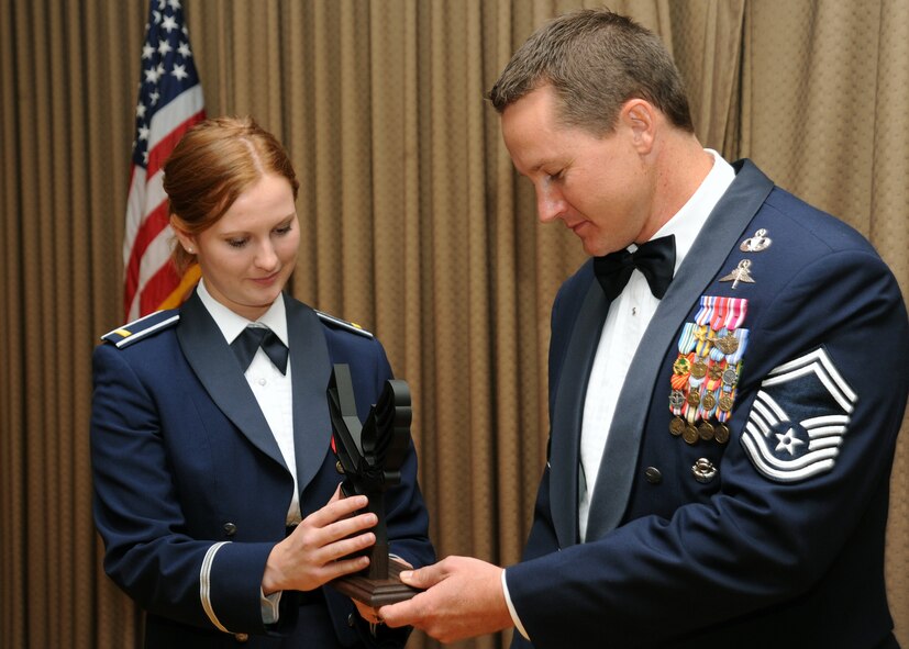 2nd Lt. Amanda Taylor, 319th Contracting Flight, presents Senior Master Sgt. Michael Stockdale, Pope Air Force Base, 24th Special Tactics Squadron with a token of appreciation from the 319th Air Base Wing during the Air Force Ball Sept. 17, 2011. Sergeant Stockdale is a veteran of the Battle of Tora Bora in Afghanistan and was awarded the Silver Star for gallantry when he directly engaged in combat actions against the Taliban and Al Qaeda forces.  (U.S. Air Force photo by Senior Airman Amber E. Bennett)