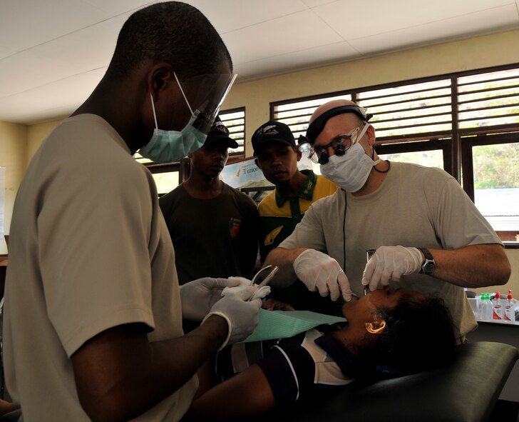 COM, Timor Leste--U.S. Air Force Staff Sgt. Richard Glass, dental assistant, prepares a 151 extraction tool for U.S. Air Force Capt. Frances Becker, dentist, for an extraction of Lanjina de Castro's left-upper molar here Sept.19. Both Glass and Becker are from Misawa Air Base, Japan. Operation Pacific Angel is a joint and combined humanitarian assistance operation led by 13th Air Force at Joint Base Pearl Harbor-Hickam, Hawaii. The operation supports U.S. Pacific Command's capacity-building efforts by partnering with other governments in the region to provide medical, dental, optometry, veterinary and engineering assistance to their citizens. (U.S. Air Force photo/Tech. Sgt. Phillip Butterfield) 