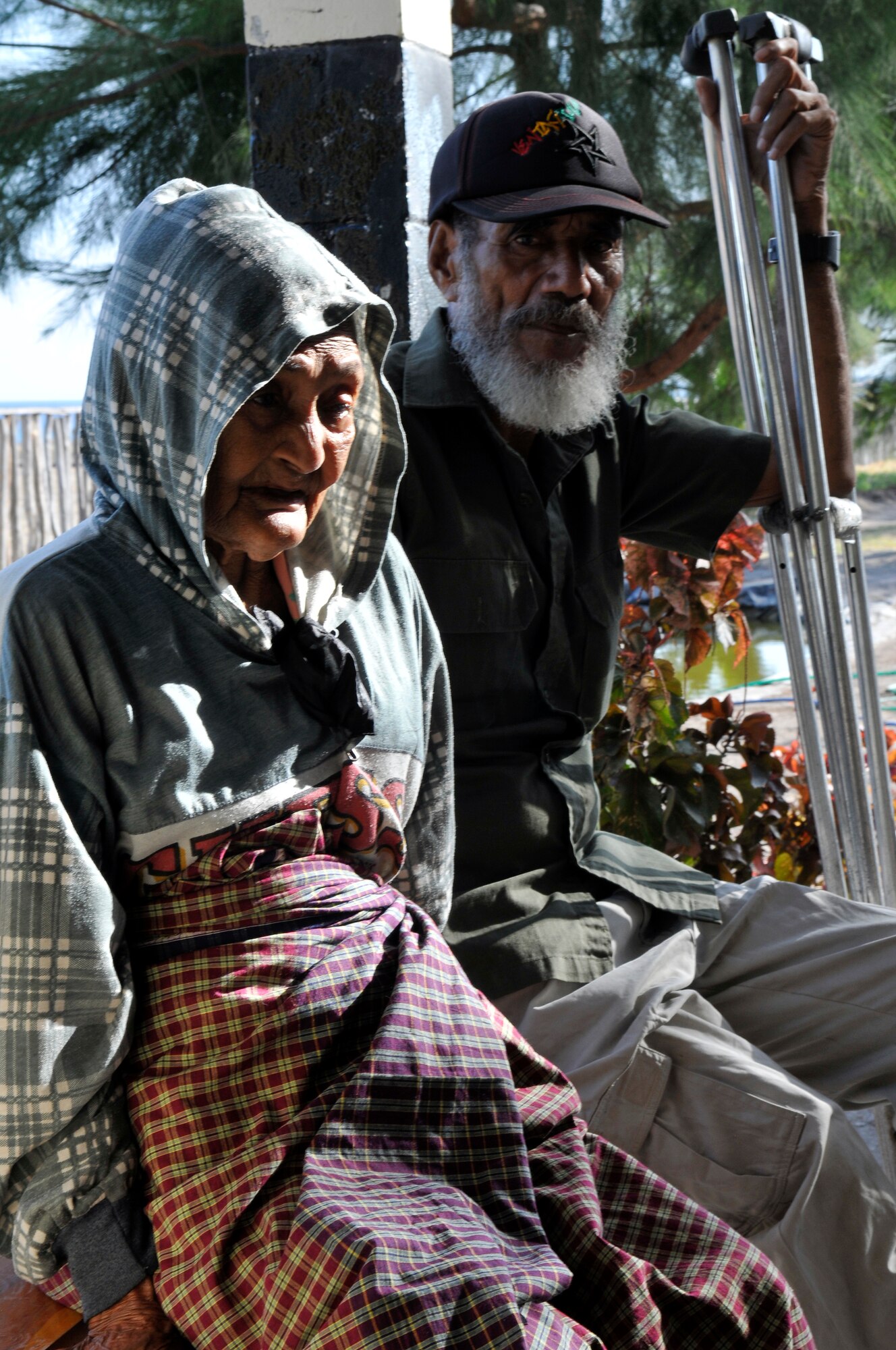 COM, Timor Leste-- An elderly couple, wait to be registered so they can receive medical care at the clinic Pacific Angel servicemembers setup at the Com primary school Sept. 19. Before lunch, the clinic registered and attended to 130 cases and expect a greater number afterward. Officially in its fourth year, Operation Pacific Angel is a joint and combined humanitarian assistance operation led by 13th Air Force at Joint Base Pearl Harbor-Hickam, Hawaii. The operation supports U.S. Pacific Command's capacity-building efforts by partnering with other governments in the region to provide medical, dental, optometry, veterinary and engineering assistance to their citizens. (USAF photo by Tech. Sgt. Phillip Butterfield)