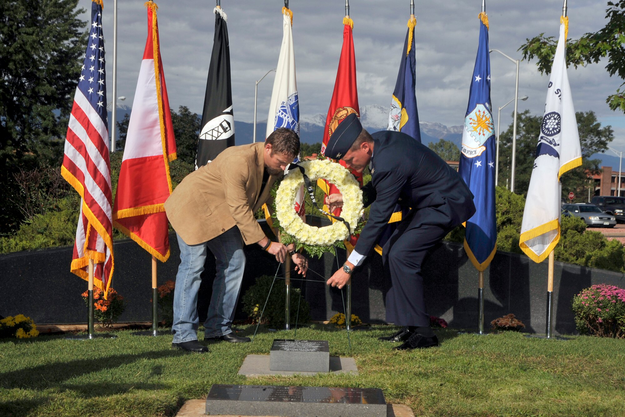 John Wall, LifeQuest Transitions, and Col. Michael Burke, 21st Medical Group commander, place a wreath Sept. 16, 2011, in honor of POW/MIA week at the Peterson chapel. (U.S. Air Force photo/Dennis Howk)