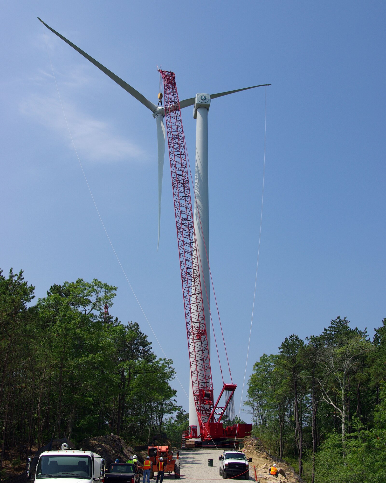 MASSACHUSETTS MILITARY RESERVE, Mass. -- Contractors at the Massachusetts Military Reserve, Mass., maneuver through the narrow construction site to install wind turbine blades on one of two wind turbines under construction there. Once complete and operational, the 390-feet turbines are expected to result in "100-percent, on-site renewable" status for the installation. Courtsy photo by Scott DEHainaut