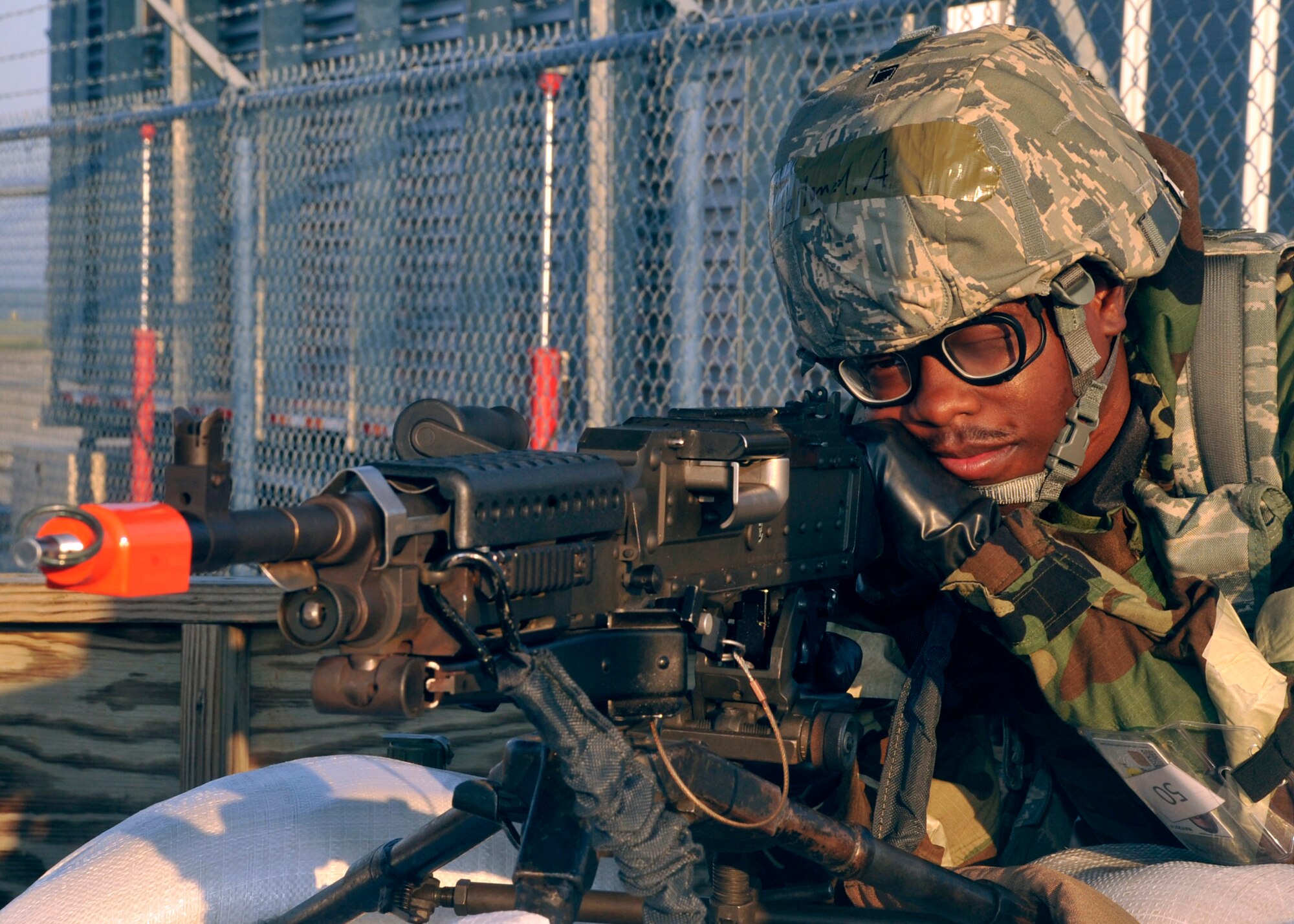 Airman 1st Class Aaron Holland, a combat arms training instructor with the 436th Security Forces Squadron, sights in his M-240 Bravo on Sept. 14, 2011, at the Combat Readiness Training Center in Gulfport, Miss. Holland performed entry control point security from a watchtower on the flightline during Dover Air Force Base's Operation Readiness Exercise. (U.S. Air Force photo by Tech. Sgt. Chuck Walker)