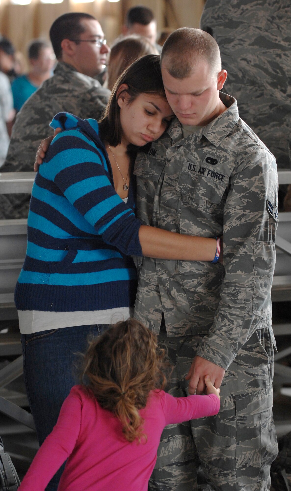 A U.S. Air Force Airman First Class with the 20th Equipment Maintenance Squadron holds his wife and daughter before deploying, Shaw Air Force Base, SC., Sept. 19, 2011. (U.S. Air Force photo by Airman First Class Hunter Brady/Released)



