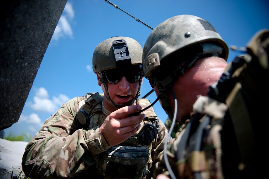 U.S. Air Force Senior Airman Jess Hager, 11th Air Support Operations Squadron joint terminal attack controller, left, communicates with an aircrew during exercise Atlantic Strike 11-02 at Avon Park Air Force Range, Fla., Sept. 14, 2011. Hager’s job as a JTAC was to direct the actions of combat aircraft engaged in close air support. Hager is stationed out of Fort Hood, Texas. (U.S. Air Force photo by Staff Sgt. Jamal D. Sutter/Released)