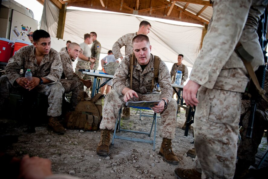 U.S. Marine Corps Sgt. Shelby Mangiaracina, 2nd Tank Battalion section leader, conducts an debrief during exercise Atlantic Strike 11-02 at Avon Park Air Force Range, Fla., Sept. 13, 2011. During the brief, Mangiaracina discussed the positives and negatives of their training mission and how well they provided support for U.S. Air Force joint terminal attack controllers. (U.S. Air Force photo by Staff Sgt. Jamal D. Sutter/Released)