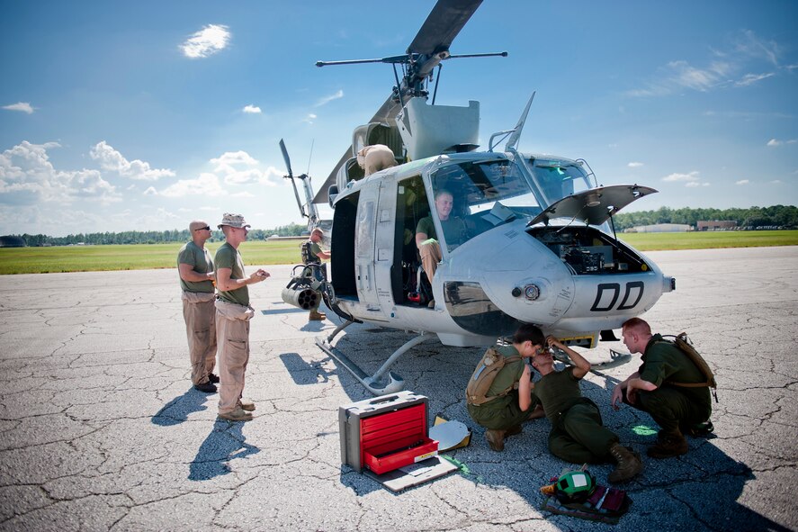 U.S. Marine Corps members of Marine Light Attack Helicopter Squadron (HMLA) 467 conduct maintenance on a UH-1N Huey during exercise Atlantic Strike 11-02 at Avon Park Air Force Range, Fla., Sept. 12, 2011. The Huey was used to conduct air strikes as directed by joint terminal attack controllers. The HMLA-467 is based at Marine Corps Air Station Cherry Point, N.C., and falls under the command of Marine Aircraft Group 29 and 2nd Marine Aircraft Wing.  (U.S. Air Force photo by Staff Sgt. Jamal D. Sutter/Released) 