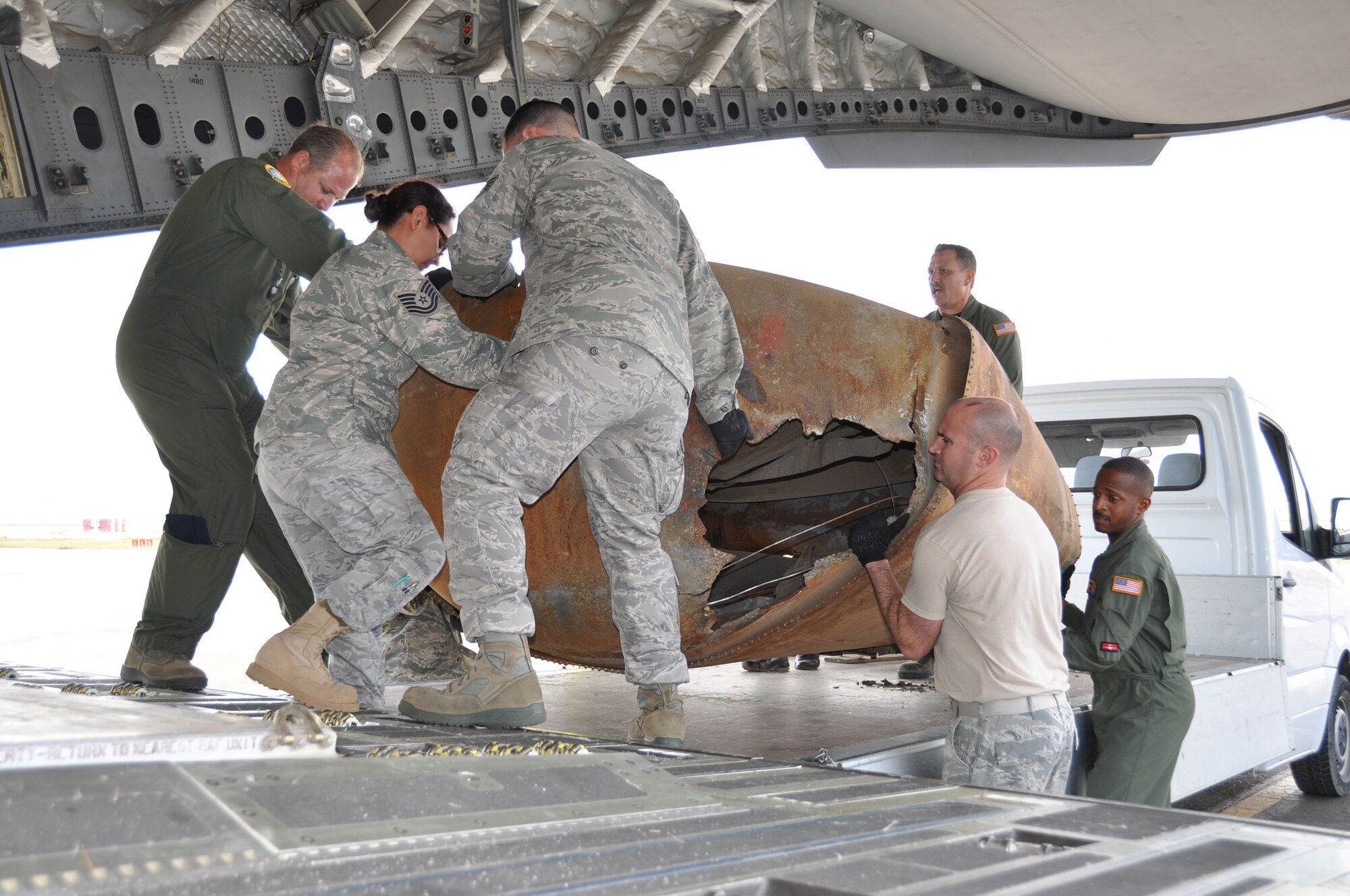 Air Force reservists hoist a 480-pound rocket part into a C-17 Globemaster III, Aug. 26, 2011.  The aircraft was in Mongolia from the 729th Airlift Squadron at March Air Reserve Base, Calif., to retrieve fallen space debris.  (U.S. Air Force photo/Master Sgt. Linda Welz)