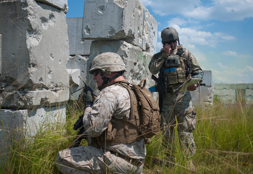 U.S. Air Force Senior Airman Jess Hager, 11th Air Support Operations Squadron joint terminal attack controller, and U.S. Marine Corps Sgt. Shelby Mangiaracina, 2nd Tank Battalion section leader, look over maps and coordinate with aircrew to provide close air support during Exercise Atlantic Strike Sept. 13, at Avon Park Air Force Training Range. Atlantic Strike gave JTACs, who typically work with Army joint fires observers, a chance to train with Marine air naval gunfire liaisons.  (U.S. Air Force photo by Airman 1st Class Jarrod Grammel/Released)
