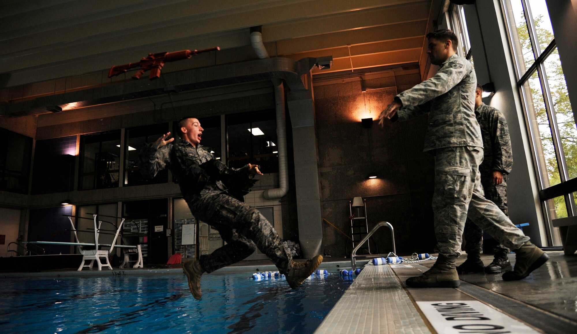 WARRENSBURG, Mo. - Airman 1st Class Brian Whitaker, 509th Security Forces Squadron member, is shoved into a pool during water survival training Sept. 16. Whitaker is one of four Airmen from the 509th SFS training for the opportunity to attend the Air Force Pre-Ranger Course. The Airman that shows the most leadership abilities and highest physical and mental endurance throughout training will be sent to the course. (U.S. Air Force photo by Senior Airman Cody H. Ramirez)
