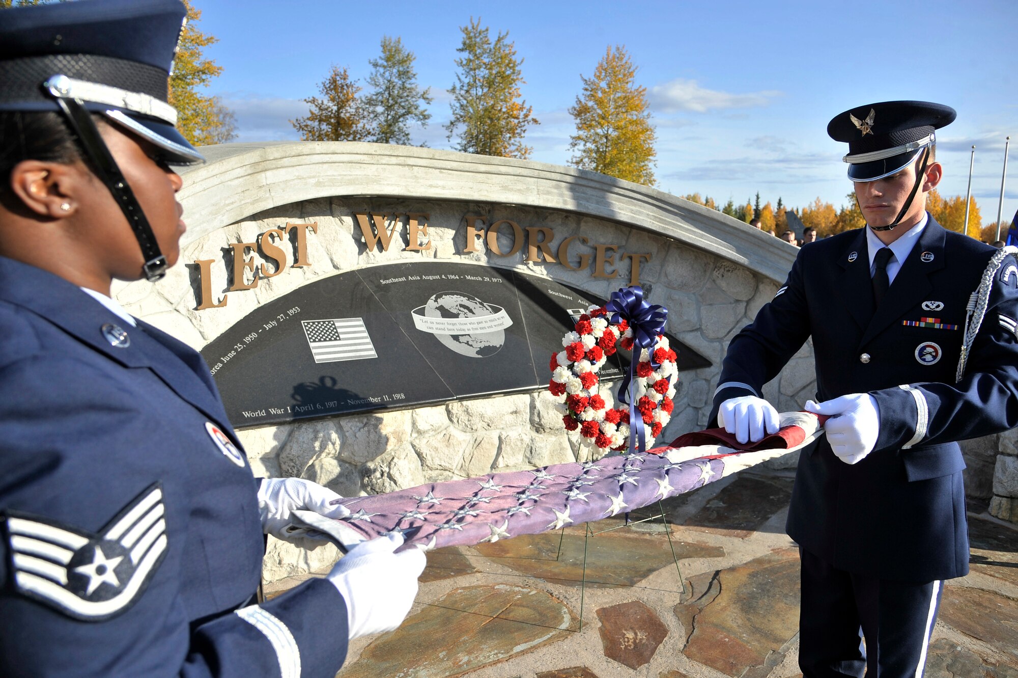 Staff Sgt. Davita Vega and Airman 1st Class Joshua Rugloski fold the flag during the Prisoner of War and Missing in Action ceremony at Heritage Park Sept. 16, 2011, Eielson Air Force Base, Alaska. The POW/MIA ceremony pays tribute to those who are classified as captured or missing in action during war. Sergeant Vega and Airman Rugloski are members of the Eielson Honor Guard. (U.S. Air Force photo/Staff Sgt. Christopher Boitz)