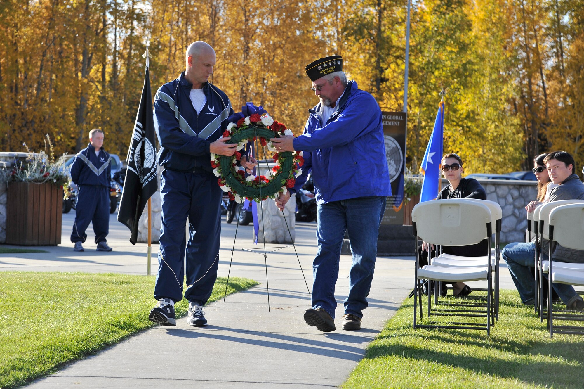 Brig. Gen. James Post and Edward Constantine carry a wreath to be placed at the Prisoner of War and Missing in Action memorial at Heritage Park Sept. 16, 2011, Eielson Air Force Base, Alaska. The POW/MIA ceremony pays tribute to those who are classified as captured or missing in action during war. General Post is the 354th Fighter Wing commander. Mr. Constantine is the past Post Commander of Veterans of Foreign Wars Post 10029. (U.S. Air Force photo/Staff Sgt. Christopher Boitz)