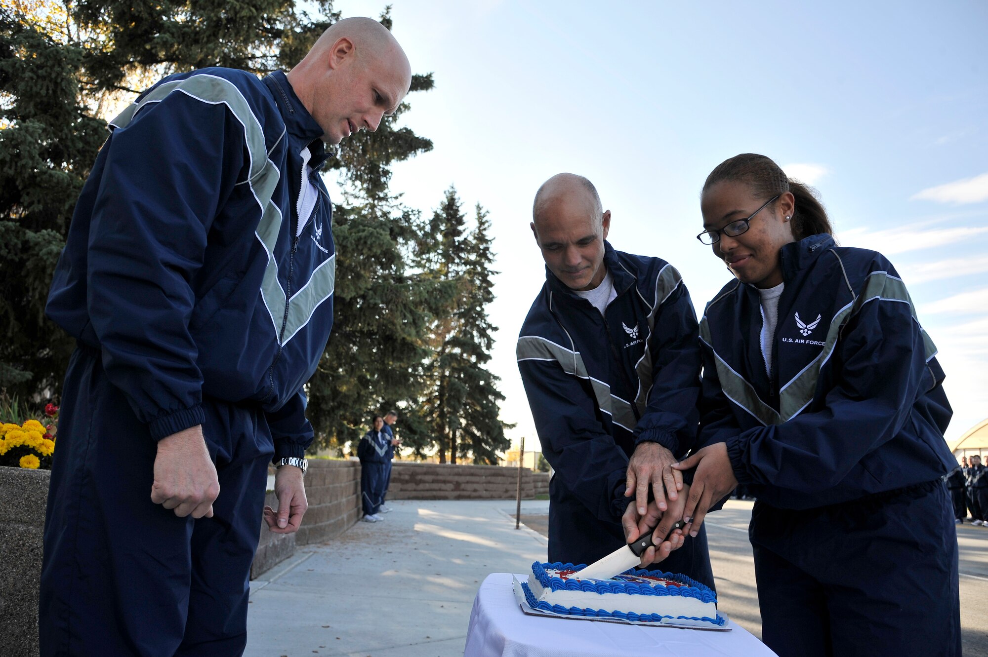 Brig. Gen. James Post oversees Lt. Col. Roscoe Van Camp and Airman 1st Class Martina Nielsen as they cut the Air Force birthday cake Sept. 16, 2011, Eielson Air Force Base, Alaska. The Iceman Team celebrated 64 years of service with a wing run followed by a Prisoner of War and Missing in Action ceremony. General Post is the 354th Fighter Wing commander. (U.S. Air Force photo/Staff Sgt. Christopher Boitz)