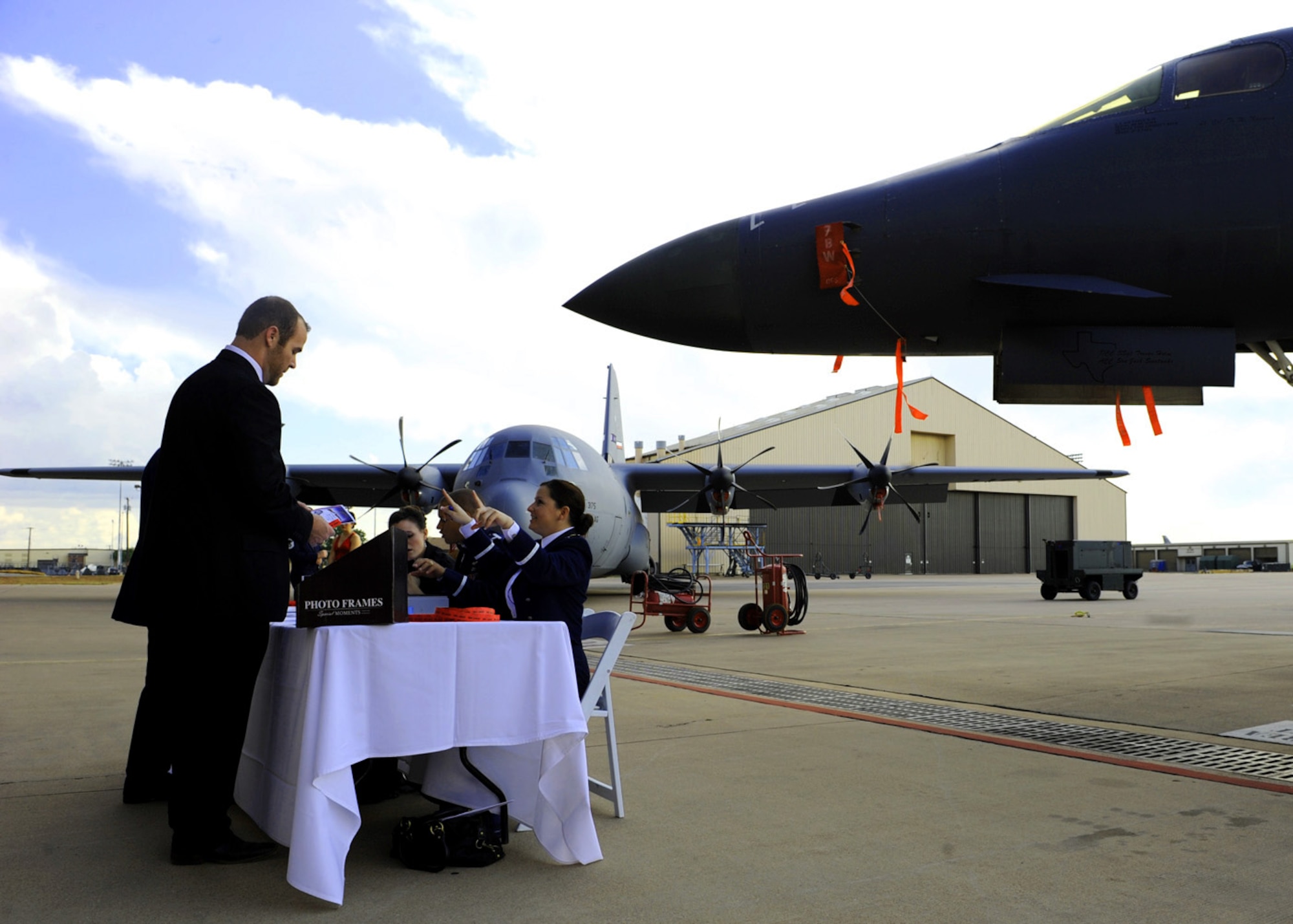 Airmen pay for a ticket into the Air Force Ball Sept. 17, 2011 to celebrate the 64th anniversary of the Air Force at Dyess Air Force Base Texas. The Air Force was established on September 18, 1947 when President Harry Truman signed the National Security Act of 1947. (U.S. Air Force photo by Airman 1st Class Jonathan Stefanko/ Released)