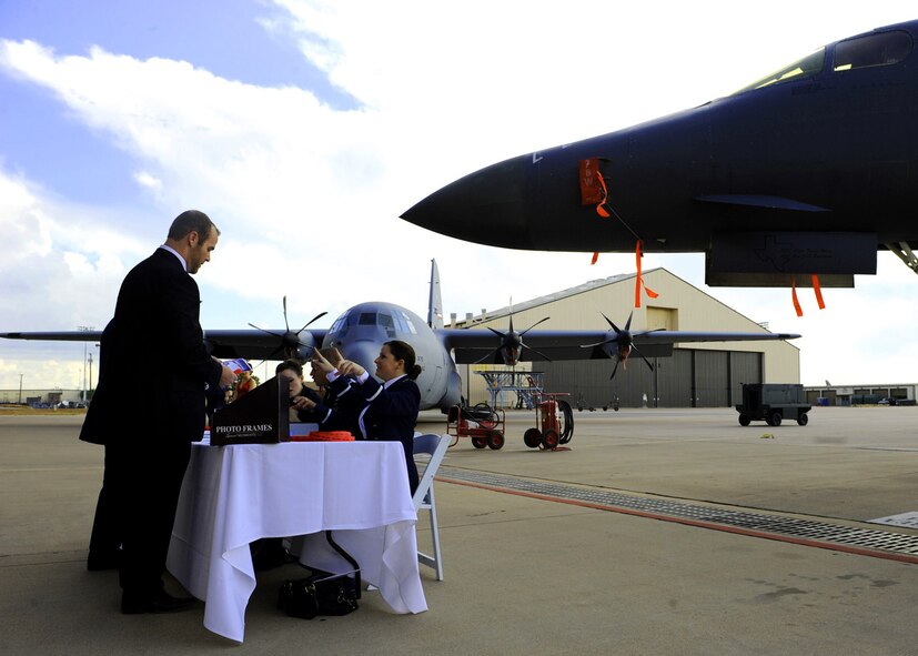 Airmen pay for a ticket into the Air Force Ball Sept. 17, 2011 to celebrate the 64th anniversary of the Air Force at Dyess Air Force Base Texas. The Air Force was established on September 18, 1947 when President Harry Truman signed the National Security Act of 1947. (U.S. Air Force photo by Airman 1st Class Jonathan Stefanko/ Released)