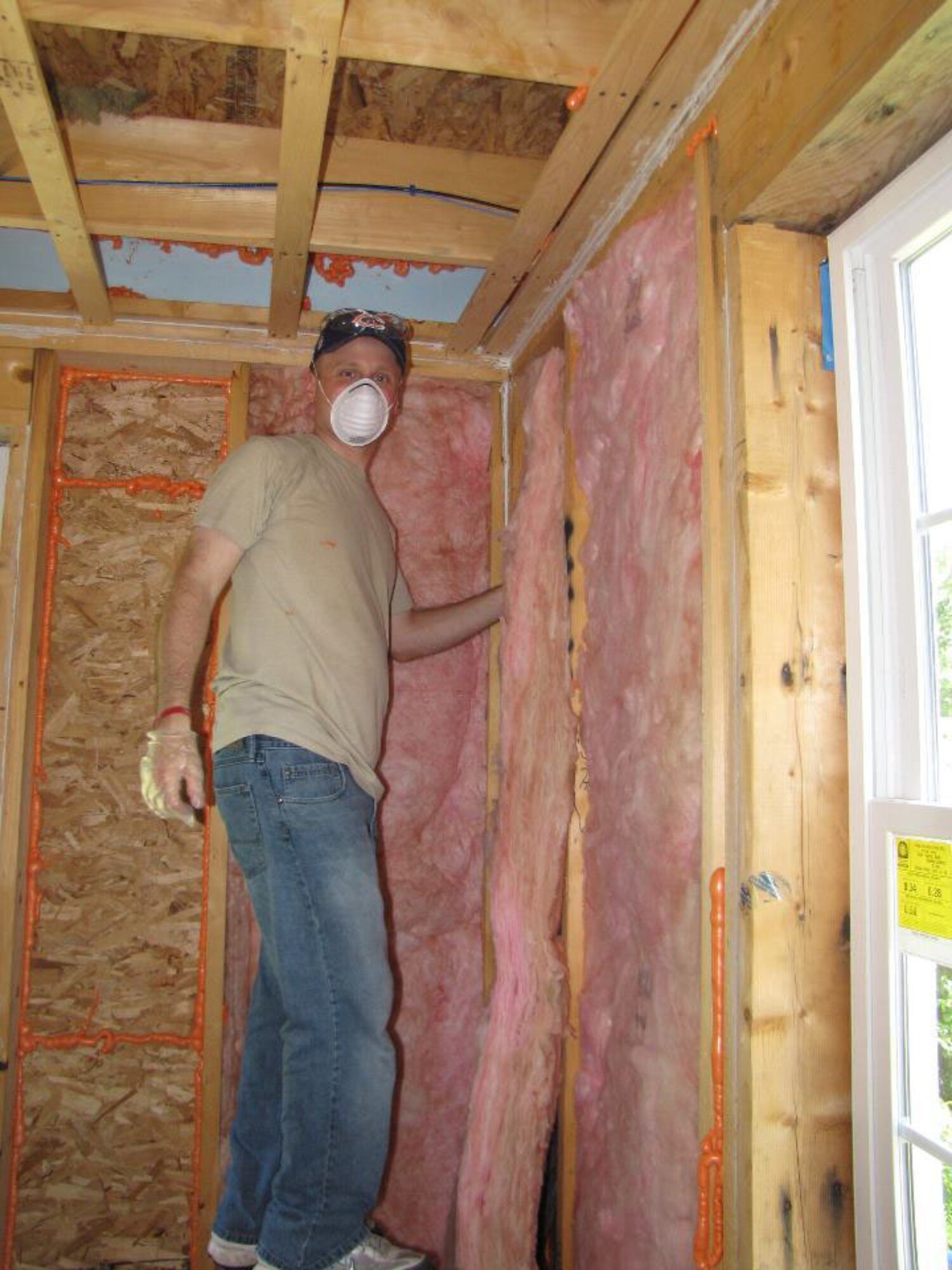Greg Taylor, PESystems contractor, helps install insulation for a Habitat for Humanity project in Bedford, Mass., Aug. 26. Mr. Taylor is part of a group of military, civilian and contractor personnel from Hanscom's Battle Management Directorate who are volunteering their time to assist with building affordable homes for low-income families. (Courtesy photo)