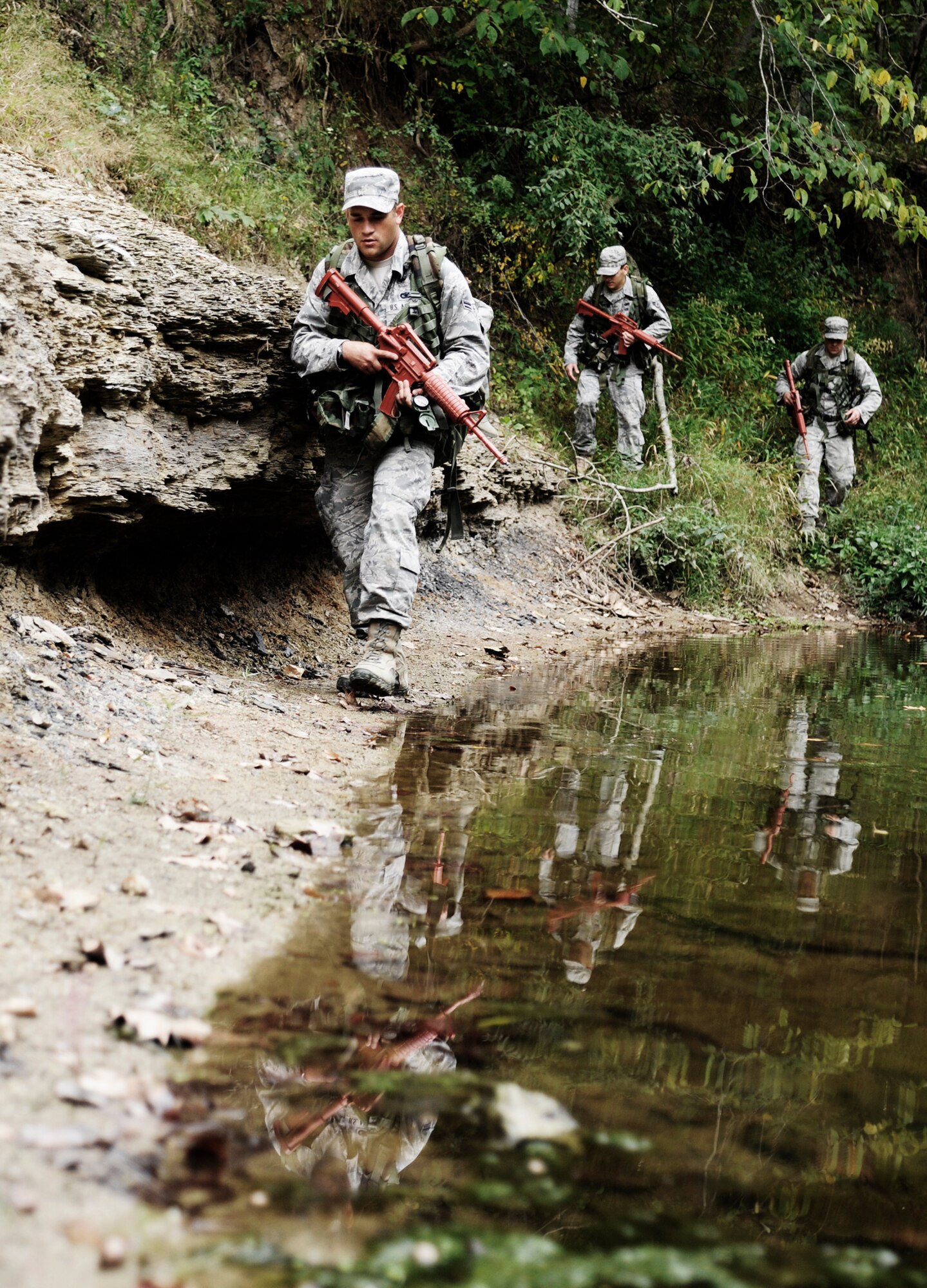 KNOB KNOSTER, Mo. - Members of the 509th Security Forces Squadron find the easiest route across a creek during land navigation training Sept. 16. The team is training and competing for the opportunity to attend the Air Force Pre-Ranger Course. One of the four will be chosen. (U.S. Air Force photo by Senior Airman Cody H. Ramirez)
