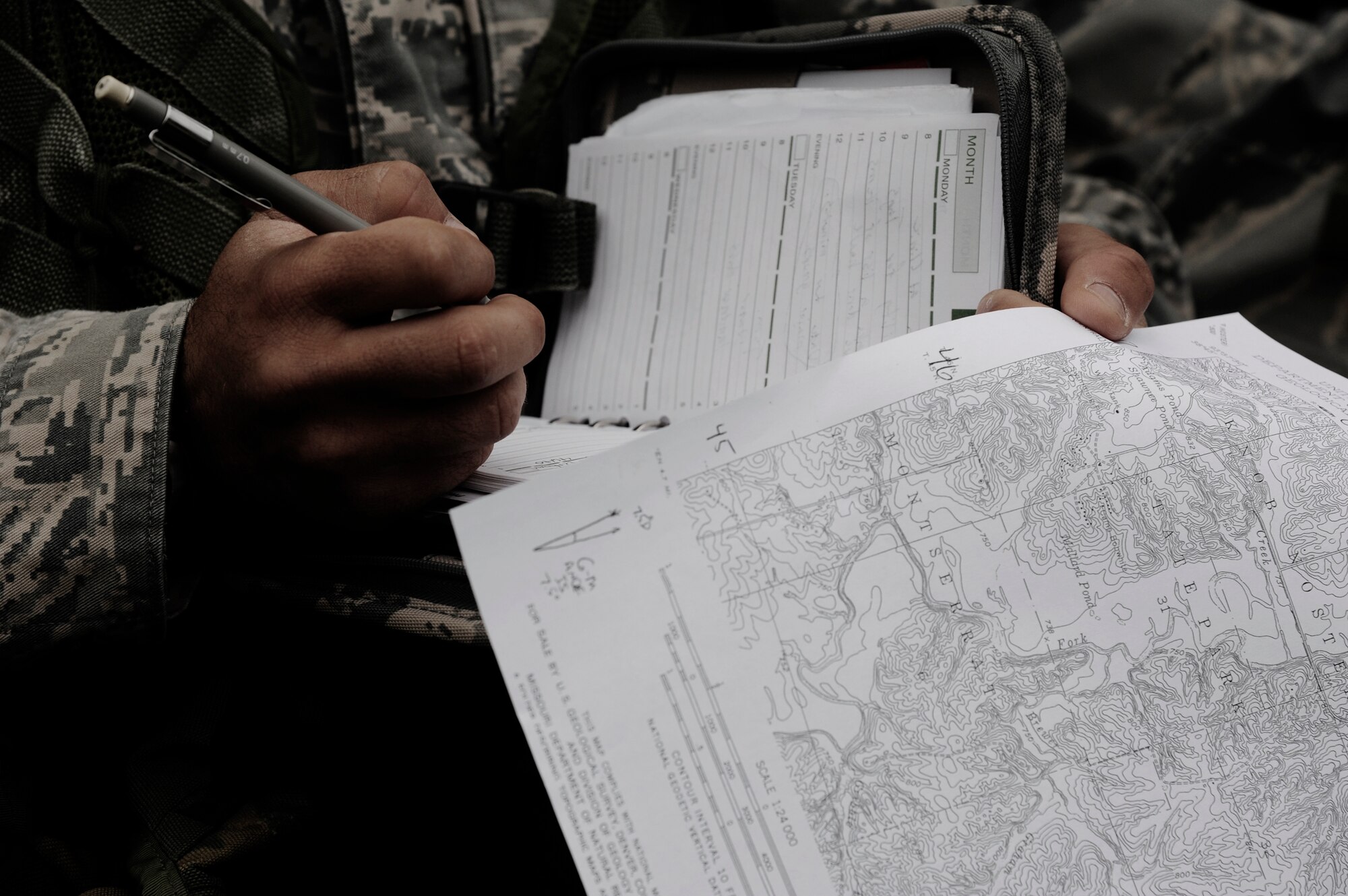 KNOB KNOSTER, Mo. - A member of 509th Security Forces Squadron marks down objective points on his map Sept. 16, during land navigation training. The Airman, along with three others from the squadron, is training on basic skills which are needed in the Air Force Pre-Ranger School (a prerequisite for ranger school). One of the four will be given the honor to attend the course. (U.S. Air Force photo by Senior Airman Cody H. Ramirez)
