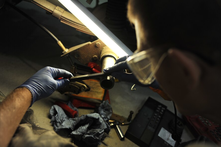 RAF MILDENHALL, England - Airman David Stribling, 100th Maintenance Squadron Aerospace Ground Equipment journeyman, cleans the threading prior to changing a wheel-bearing here Sept. 20, 2011. Precision is a must in an AGE mechanic’s duties as it’s their responsibility to ensure properly functioning equipment. (U.S. Air Force photo by Senior Airman Jerilyn Quintanilla)