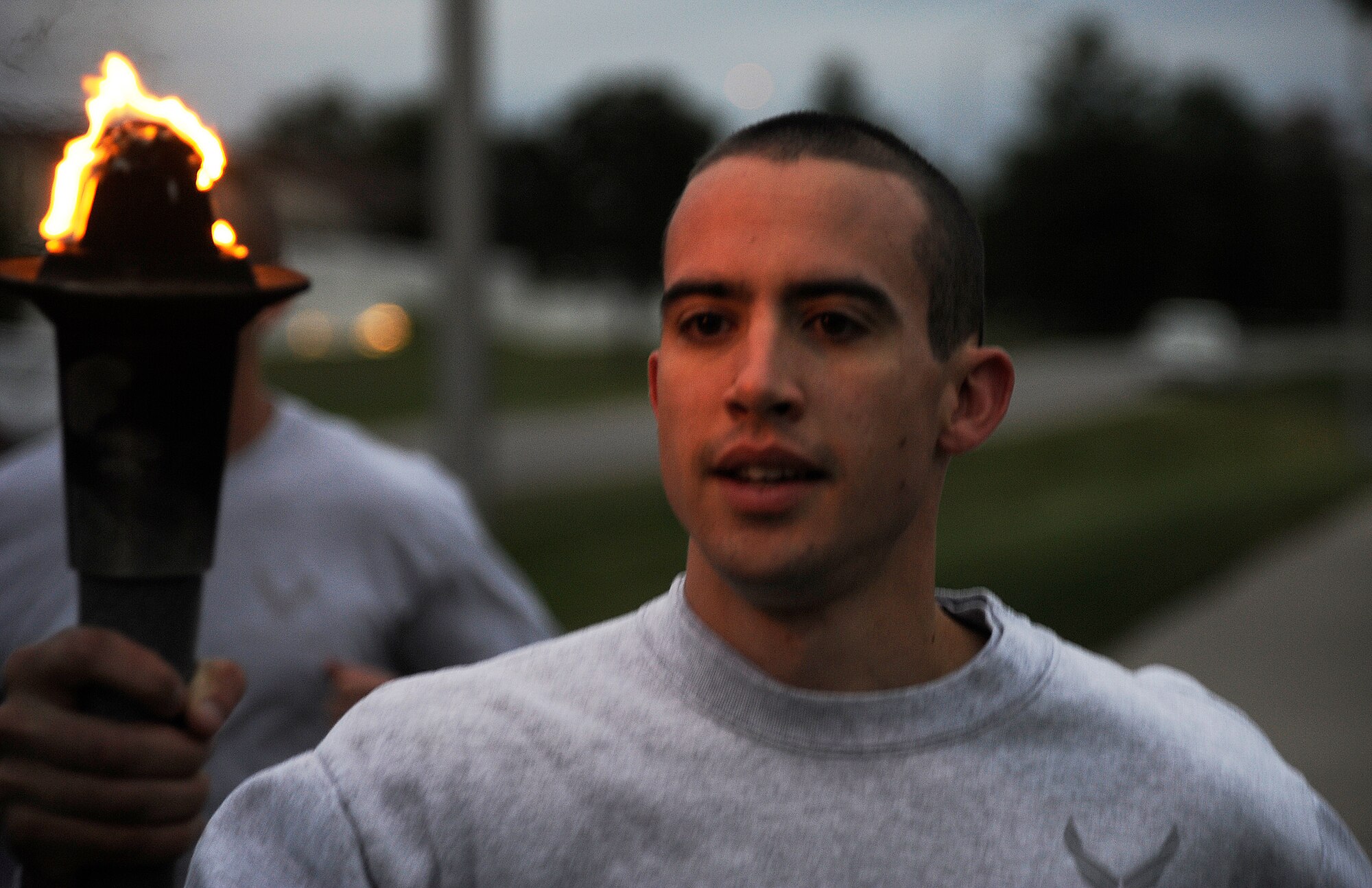 WHITEMAN AIR FORCE BASE, Mo. - An Airman holds up a torch during the POW/MIA run here Sept. 15. The run recognizes and shows respect to those who have been captured or gone missing during American military conflicts.(U.S. Air Force photo by Senior Airman Cody H. Ramirez)