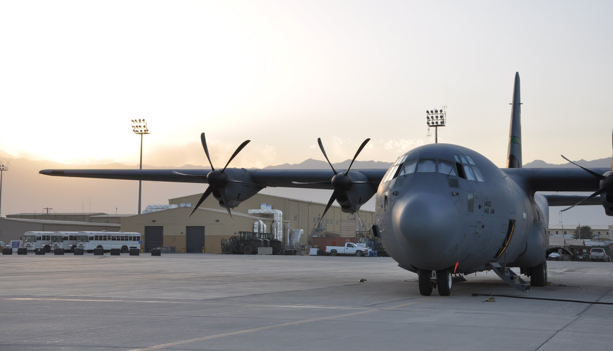 BAGRAM AIRFIELD, Afghanistan -- The sun begins to set on the horizon behind a C-130J Hercules aircraft from the 774th Expeditionary Airlift Squadron here Sept. 20, 2011. The C-130J incorporates state-of-the-art technology to reduce manpower requirements, lower operating and support costs. The aircrafts’ improved engines enables the J-model to climb faster and higher, flies farther at a higher cruise speed, and takes off and lands in a shorter distance. (U.S. Air Force photo/Staff Sgt. John Wright)