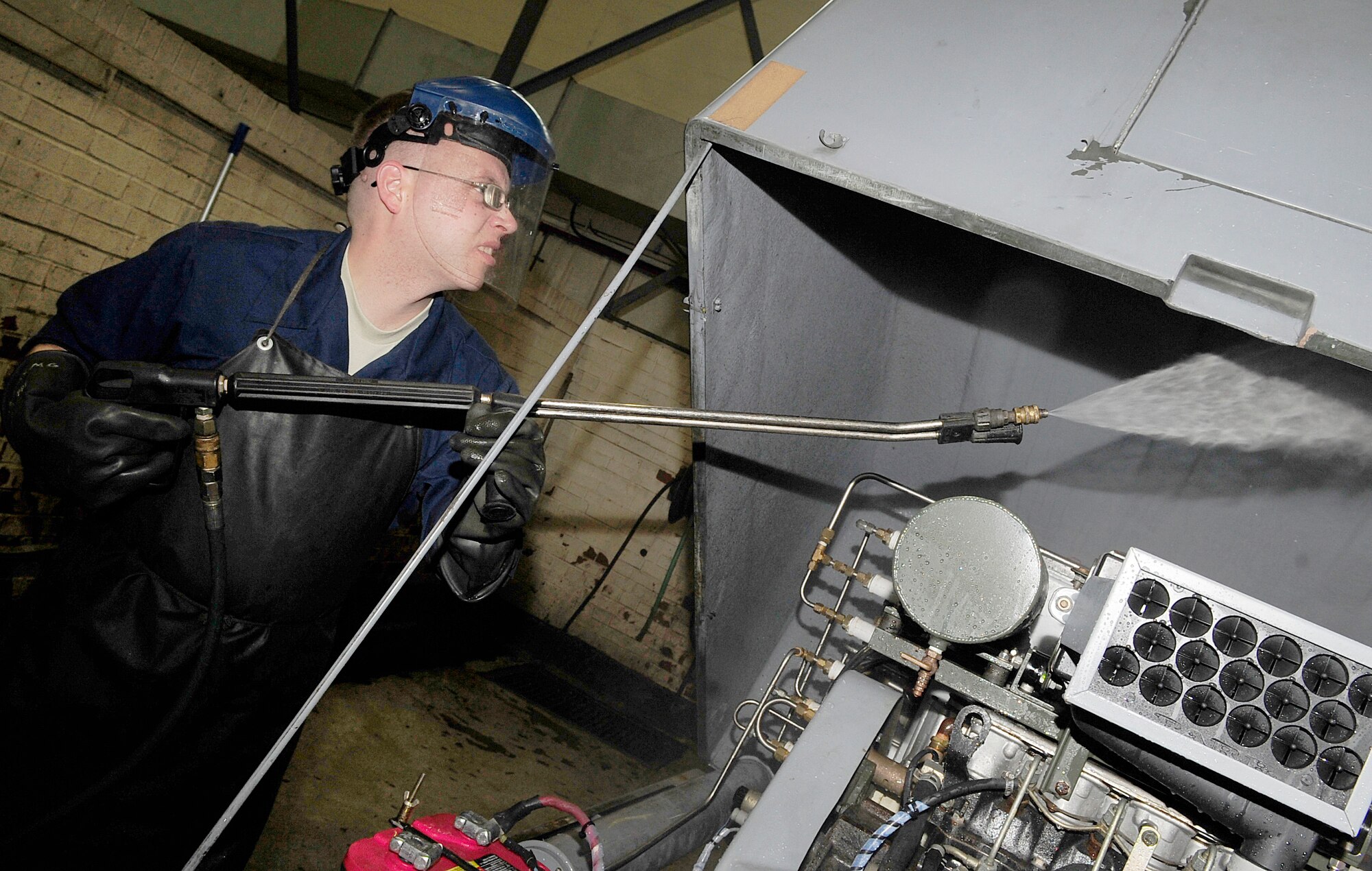 RAF MILDENHALL, England – Staff Sgt. Robert Egan, 100th Maintenance Squadron Aerospace Ground Equipment craftsman, washes a self-generating nitrogen servicing cart for its bi-annual inspection here Sept. 20, 2011. AGE is washed twice a year to help to prevent degradation and to make faults easier to spot and repair. (U.S. Air Force photo/Senior Airman Ethan Morgan) 
