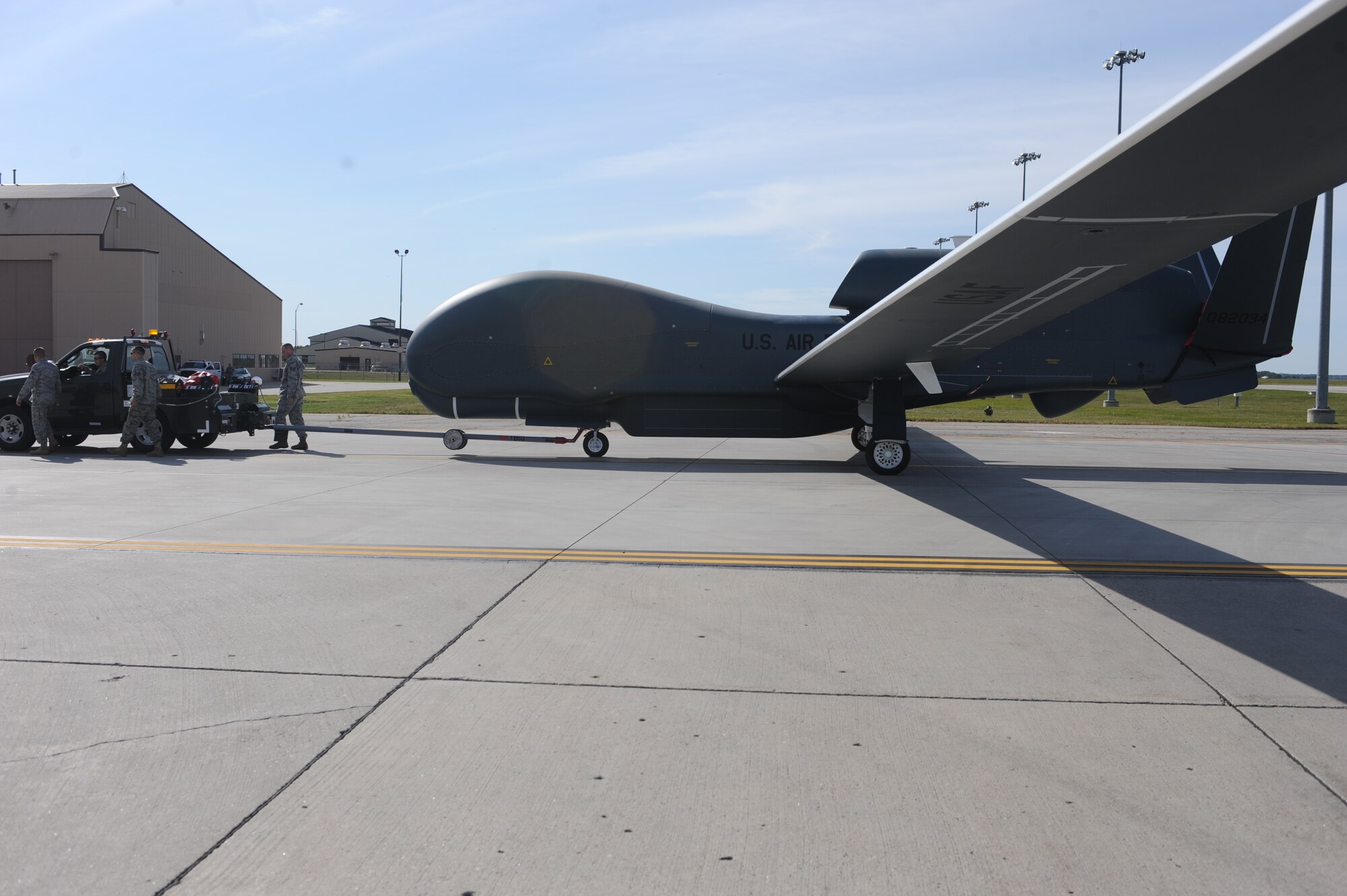 A RQ-4 Global Hawk is moved on the flight line on Grand Forks Air Force Base Sept 19. The Global Hawk covers intelligence collection capability to support forces in worldwide peace, crisis and wartime operations. The capabilities of the aircraft allow more precise targeting of weapons and better protection of forces through superior surveillance capabilities. (U.S. Air Force photo/Staff Sgt. Suellyn Nuckolls)