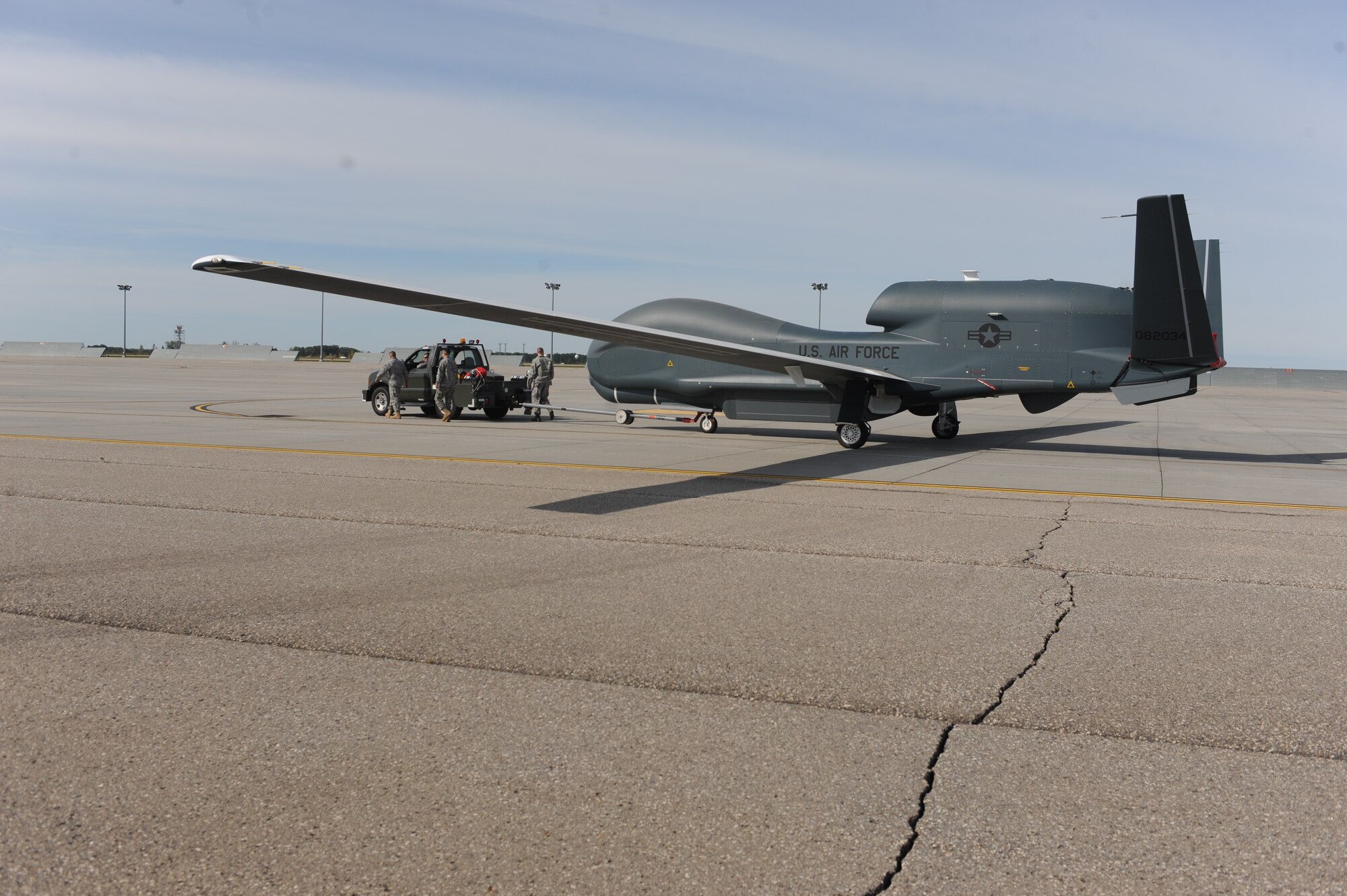 A RQ-4 Global Hawk is moved on the flight line on Grand Forks Air Force Base Sept 19. The Global Hawk covers intelligence collection capability to support forces in worldwide peace, crisis and wartime operations. The capabilities of the aircraft allow more precise targeting of weapons and better protection of forces through superior surveillance capabilities. (U.S. Air Force photo/Staff Sgt. Suellyn Nuckolls)