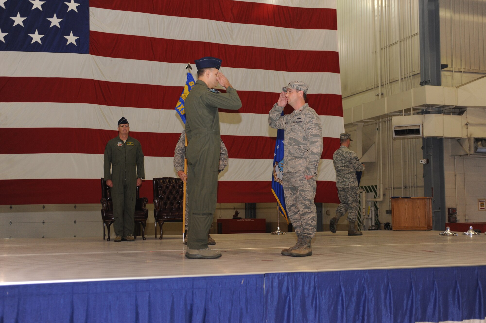 Maj. Byron Stancliff, commander, 69th Maintenance Squadron, salutes Brig. Gen. Paul McGillicuddy, commander, 9th Reconnaissance Wing during the 69th Reconnaissance Group activation of command ceremony. The 348th Reconnaissance Squadron and the 69th MXS joined together to become the 69th Reconnaissance Group. (U.S. Air Force photo/Staff Sgt. Suellyn Nuckolls)