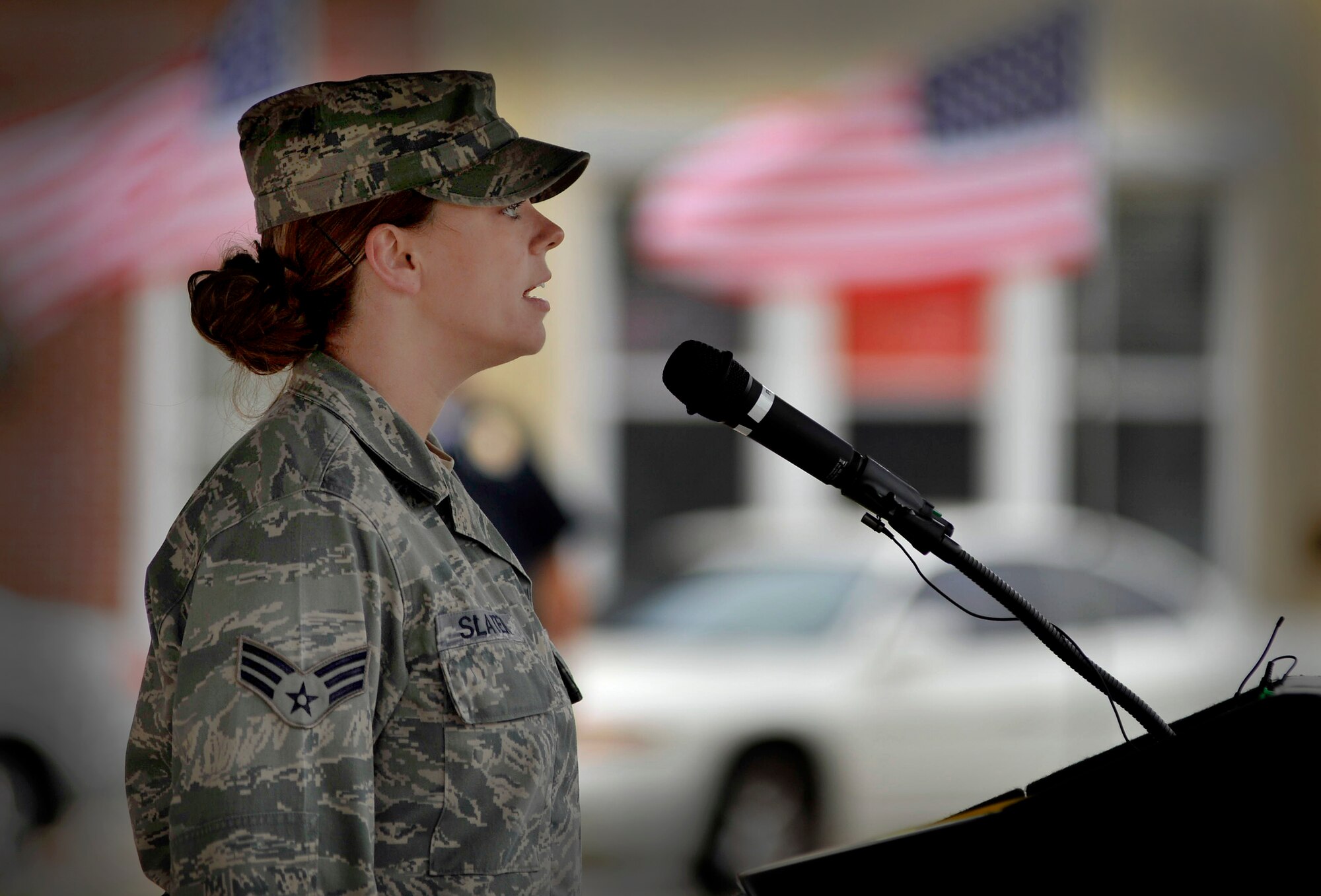U.S. Air Force Senior Airman Courtney Slater, 20th Medical Squadron, sings the National Anthem during a ceremony recognizing national prisoners-of-war and missing-in-action day, Sept. 16, 2011 Sumter, S.C. During the ceremony Louis Blanding Fowler, former prisoner of war, spoke about his service in World War II and was presented a POW/MIA flag. (U.S. Air Force photo by Senior Airman Kenny Holston/Released)


