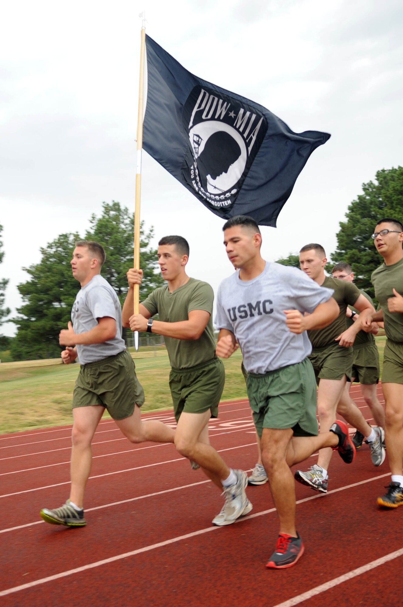 Marines from the Center for Aviation Technical Training run the final stretch of the National Prisoner of War/Missing in Action Remembrance run Sept. 16, 2011 at Little Rock Air Force Base, Ark. The run aimed to support and show appreciation to all the sacrifrices POWs endured and those MIA still endure. (U.S. Air Force photo by Staff Sgt. Jim Araos)