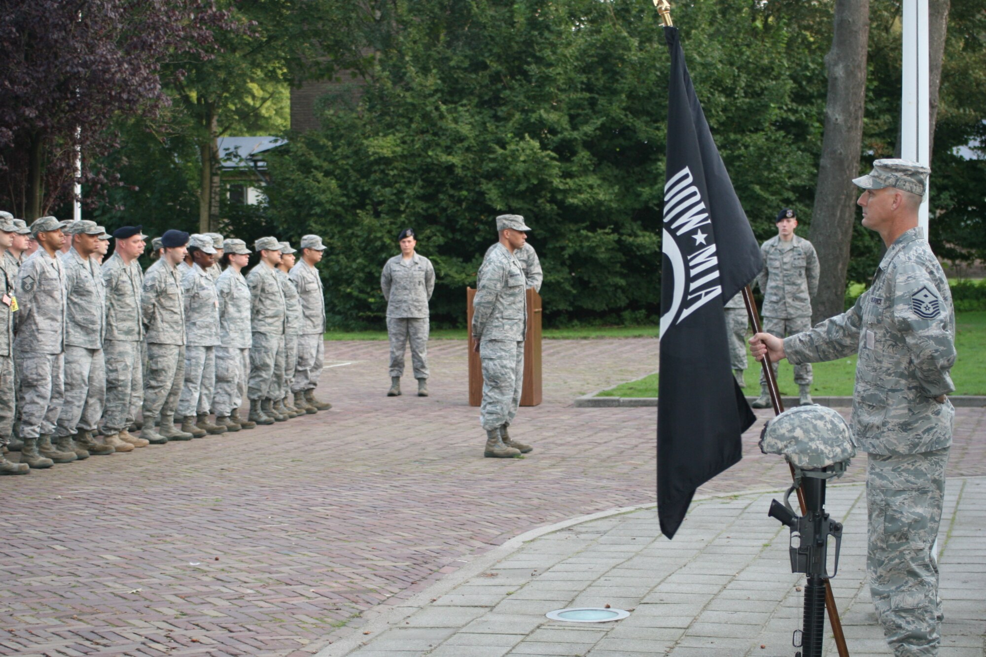 VOLKEL AIR BASE, Netherlands -- Senior Airman Justin Williams, 703rd Munitions Support Squadron, stands post with a POW/MIA flag Sept. 16 during a POW/MIA day ceremony. Members of the 703rd MUNNS volunteered to post with the flag throughout the day. The ceremony was held to commemorate those who were captured as prisoners of war and those missing in action. (U.S. Air Force photo/ Senior Airman Raymond Duesbury)