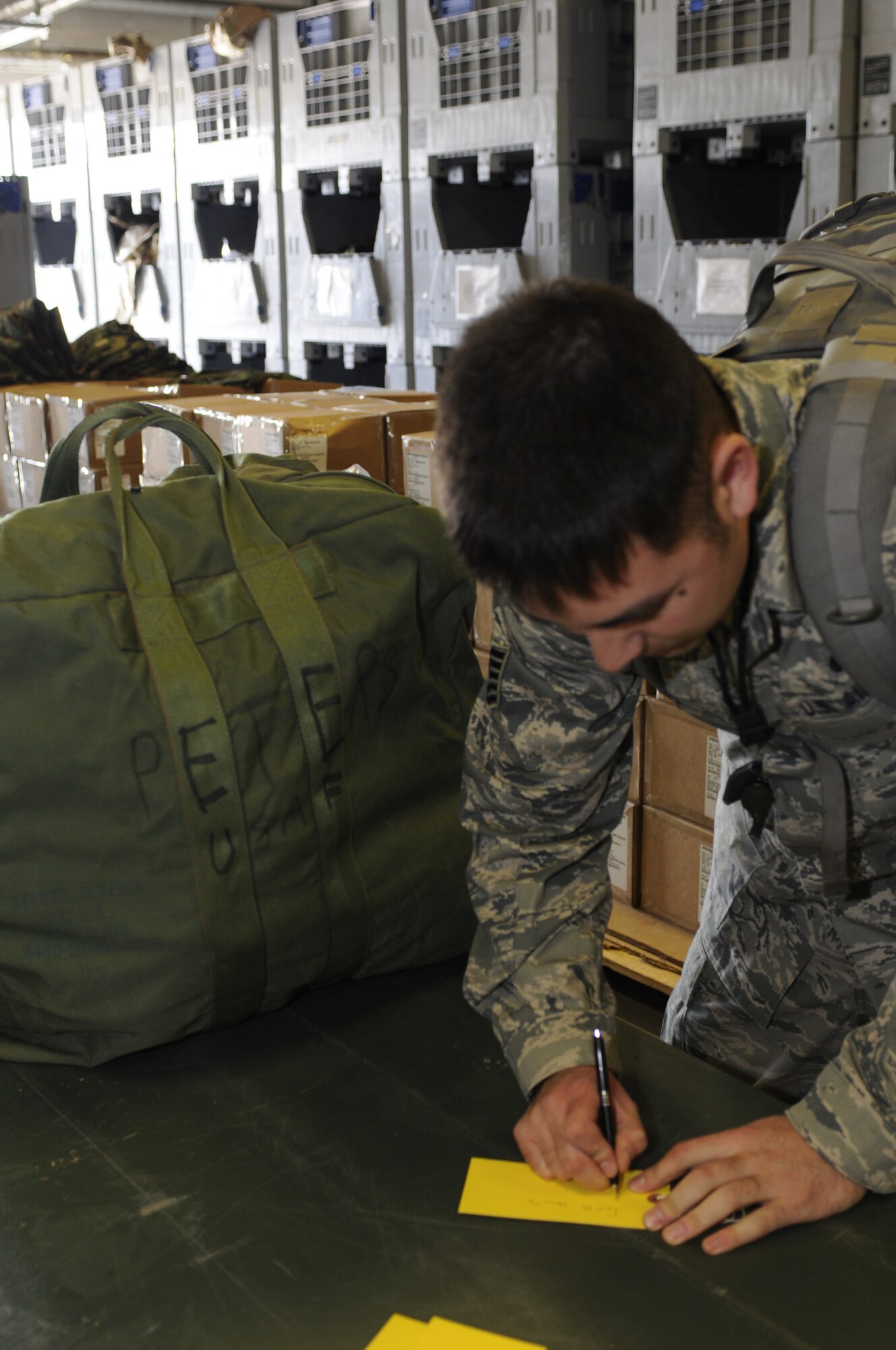 SPANGDAHLEM AIR BASE, Germany -- Tech Sgt. Steven Tolliffe, 52nd Aircraft Maintenance Sqaudron, makes a label for his deployment bag at a personnel deployment function line here. The PDF line consists of base agencies that ensure deploying members have all necessary paperwork and checklists completed before leaving. Tolliffe is deploying with the 81st Fighter Squadron in support of Operation Enduring Freedom. (U.S Air Force photo/Senior Airman Natasha E. Stannard)