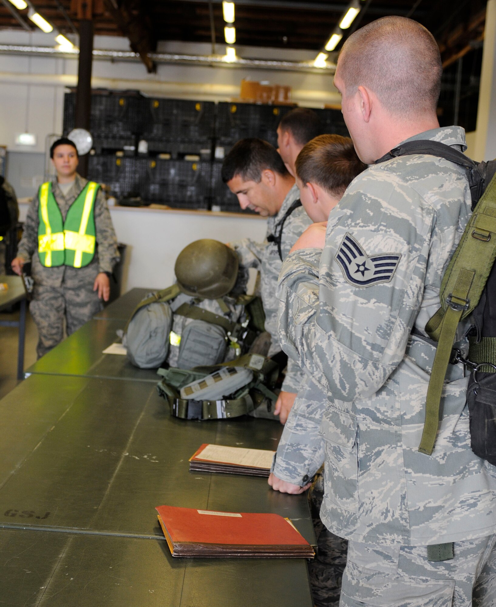 SPANGDAHLEM AIR BASE, Germany --  Airmen deploying with the 81st Fighter Squadron collect personal protective equipmen from the 52nd Logistics Readiness Squadron t at a personnel deployment function line here. The PDF line consists of base agencies that ensure deploying members have all necessary paperwork and checklists completed before leaving. (U.S Air Force photo/Senior Airman Natasha E. Stannard)