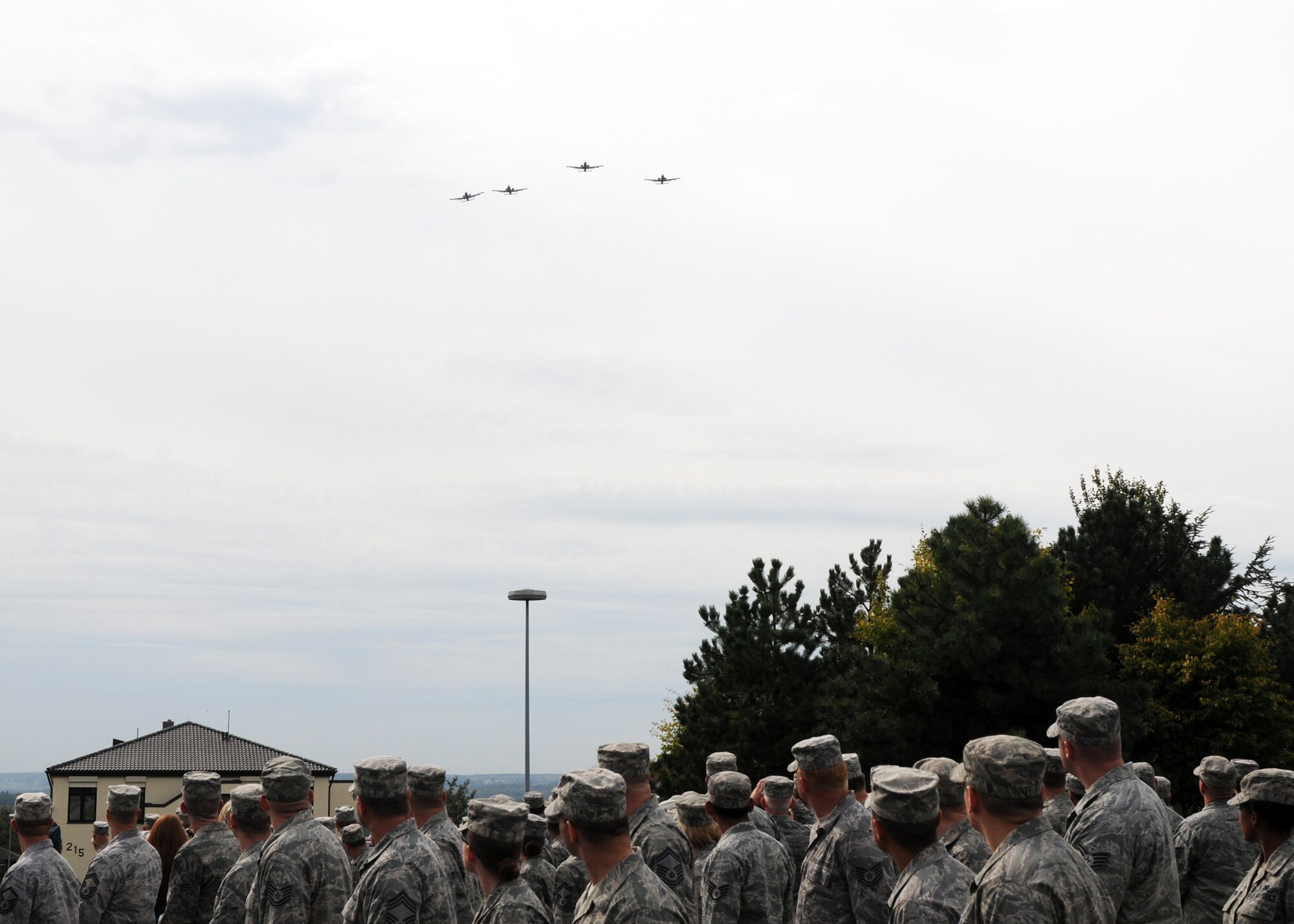 SPANGDAHLEM AIR BASE, Germany – Members of the 52nd Fighter Wing watch as four A-10 Thunderbolt II aircraft from the 81st Fighter Squadron fly over the POW/MIA ceremony at the air park here Sept. 16. The ceremony is held every year to remember those who have served and been taken prisoner or have been listed as missing in action. (U.S. Air Force photo/Senior Airman Christopher Toon) 