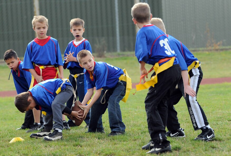 RAF MILDENHALL, England -- The RAF Mildenhall Great White Sharks offensive line start a pass-play during a youth sports flag football game Sept. 17, 2011, at Heritage Park. The Sharks were unable to best their competition from RAF Lakenheath in this season opener. Teams from RAFs Mildenhall and Lakenheath compete against each other during the season. (U.S. Air Force photo by Staff Sgt. Thomas Trower)