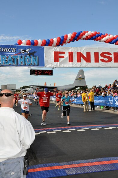 Col. Mary Aldrian, 452 AMW commander and Chief Master Sgt Deb McGuane, 336th Air Refueling Squadron's chief boomer and an unidentified runner cross the finish line after their completion of the half marathon at Wright-Patterson AFB, Ohio, Sept. 17 (U.S. Air Force Photo/Tech. Sgt. Joe Davidson)