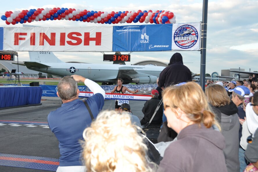 50K and Air Force Marathon record holder Josh Cox crosses the finish line after taking first place in the 10K run at the Air Force Marathon events held at Wright-Patterson AFB, Ohio, Sept. 17. (U.S. Air Force Photo/Tech. Sgt. Joe Davidson)