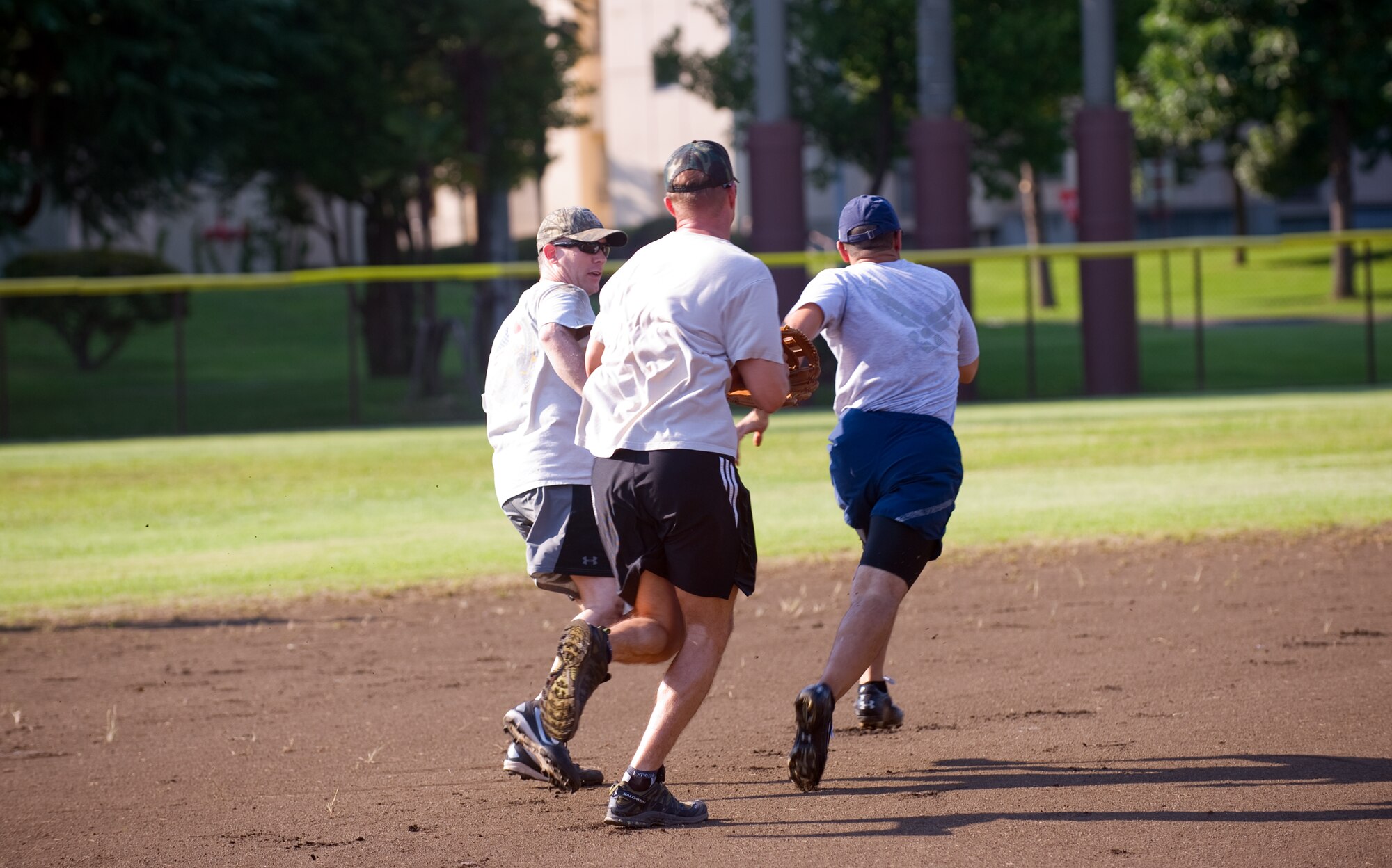 YOKOTA AIR BASE, Japan -- A chief is caught in a pickel between two colonels during the Chiefs versus Eagles softball game at Yokota Air Base, Japan, Sept.  8, 2011. At a score of 18 to 4, the Chiefs defeated the Eagles, earning bragging rights. (U.S. Air Force photo/Airman 1st Class Krystal M. Garrett)