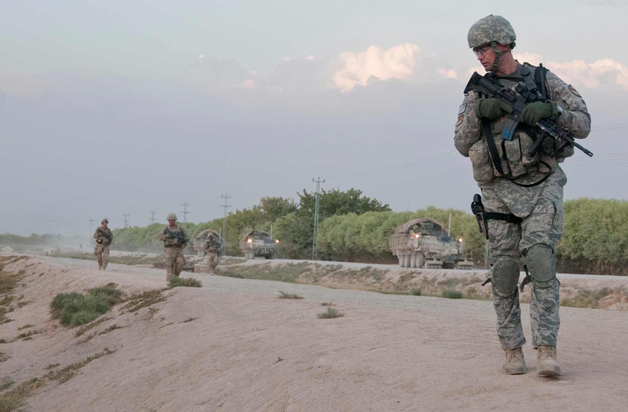 Master Sgt. Christopher Stenke, security forces adviser, 738th Air Expeditionary Advisory Group, looks into a roadside culvert, Sept. 3, 2011, during an evening foot patrol near Kandahar Airfield, Afghanistan. Stenke, a Los Angeles, Calif., native and three other Air Force security forces Airmen are responsible for training 200 Afghan Air Force security forces airmen assigned to the Kandahar Air Wing, KAF. He is deployed from Los Angeles Air Force Base, Calif. (U.S. Air Force photo by Senior Airman Jessica Lockoski 


