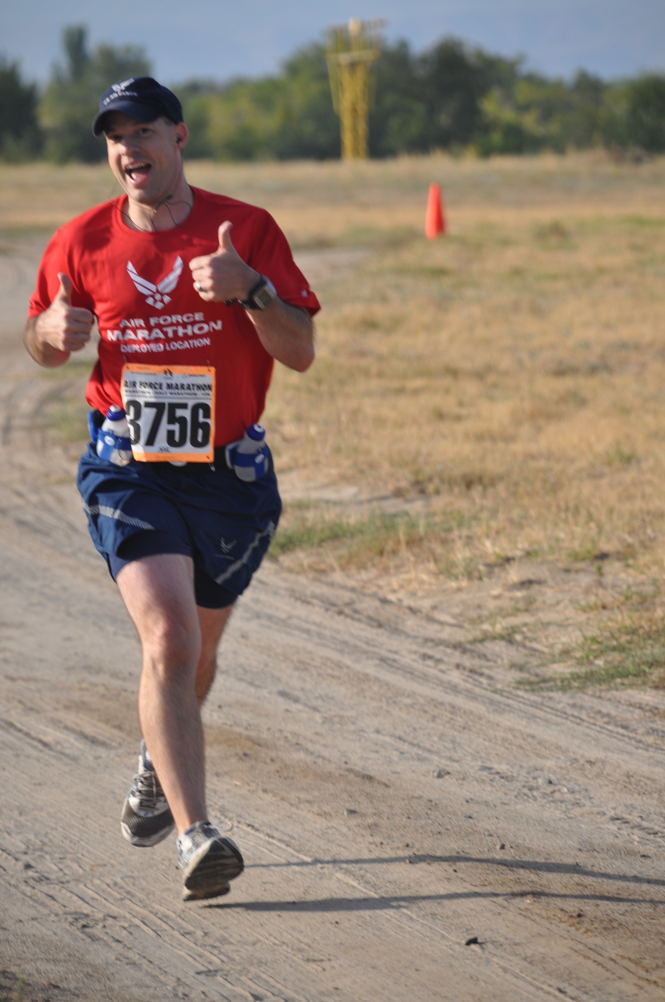 Capt. Stephen Martin gives the thumbs-up as he runs the Air Force Deployed Location Half Marathon at the Transit Center at Manas, Kyrgyzstan, Sept. 17. He is deployed to the 376th Air Expeditionary Wing Theater Security Cooperation as the Humanitarian Assistance Program medical director from Davis-Monthan Air Force Base, Ariz. (U.S. Air Force photo/Staff Sgt. Brianne Smith)