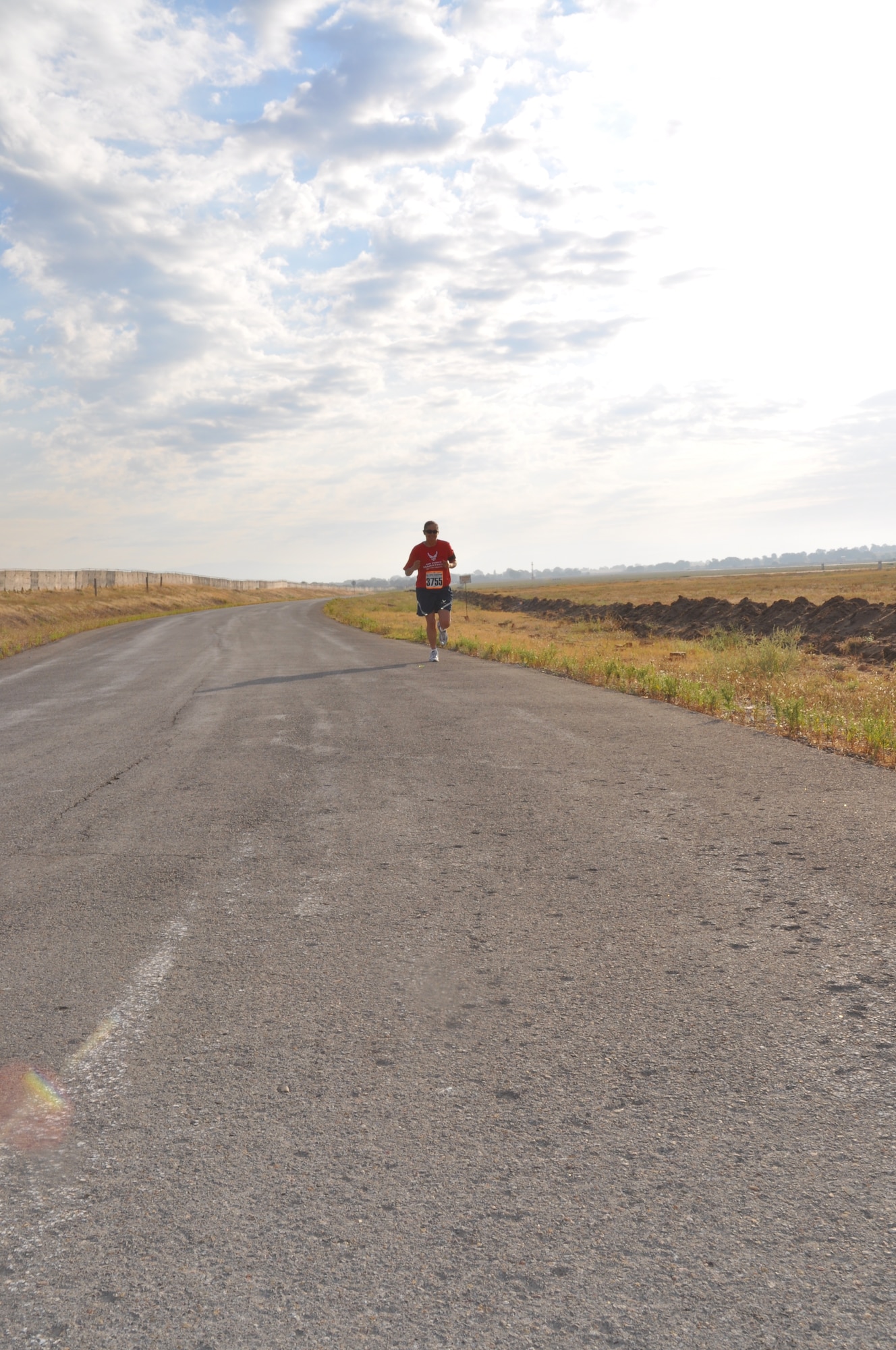 Master Sgt. Danielle Hirvela keeps pushing forward as she runs in the Air Force Deployed Location Half Marathon at the Transit Center at Manas, Kyrgyzstan, Sept. 17. Hirvela finished second in her age category. She is assigned to the 376th Expeditionary Force Support Squadron as the community service flight chief. She is deployed here from F.E. Warren Air Force Base, Wyo. (U.S. Air Force photo/Staff Sgt. Brianne Smith)