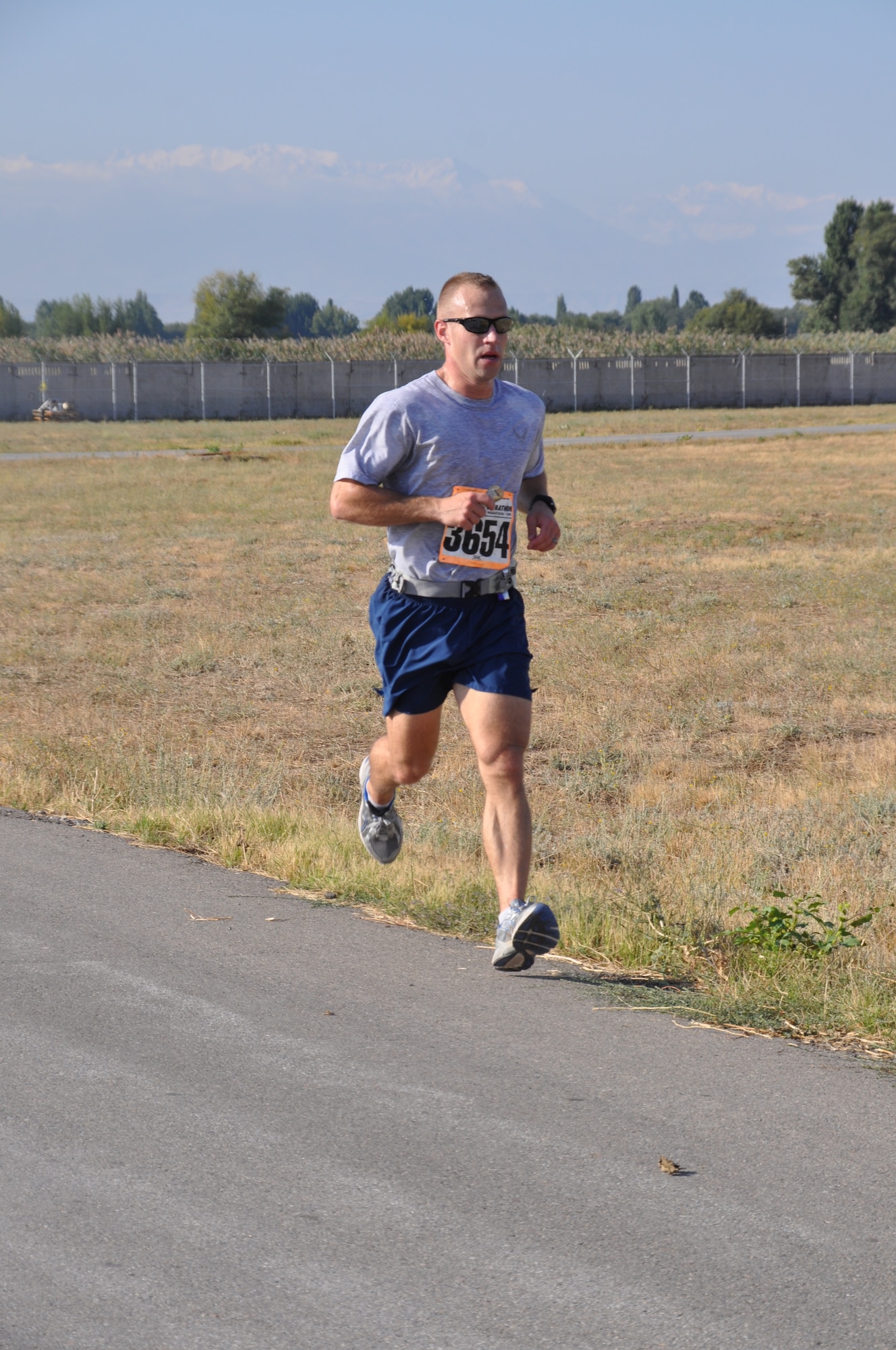 Capt. Ross Dotzlaf maintains a steady pace as he runs in the Air Force Deployed Location Marathon at the Transit Center at Manas, Kyrgyzstan, Sept. 17. Dotzlaf was the first runner to complete the race with a time of 2:58:30. He is deployed to the 376th Expeditionary Civil Engineer Squadron as the program flight commander from Peterson Air Force Base, Colo. (U.S. Air Force photo/Staff Sgt. Brianne Smith)