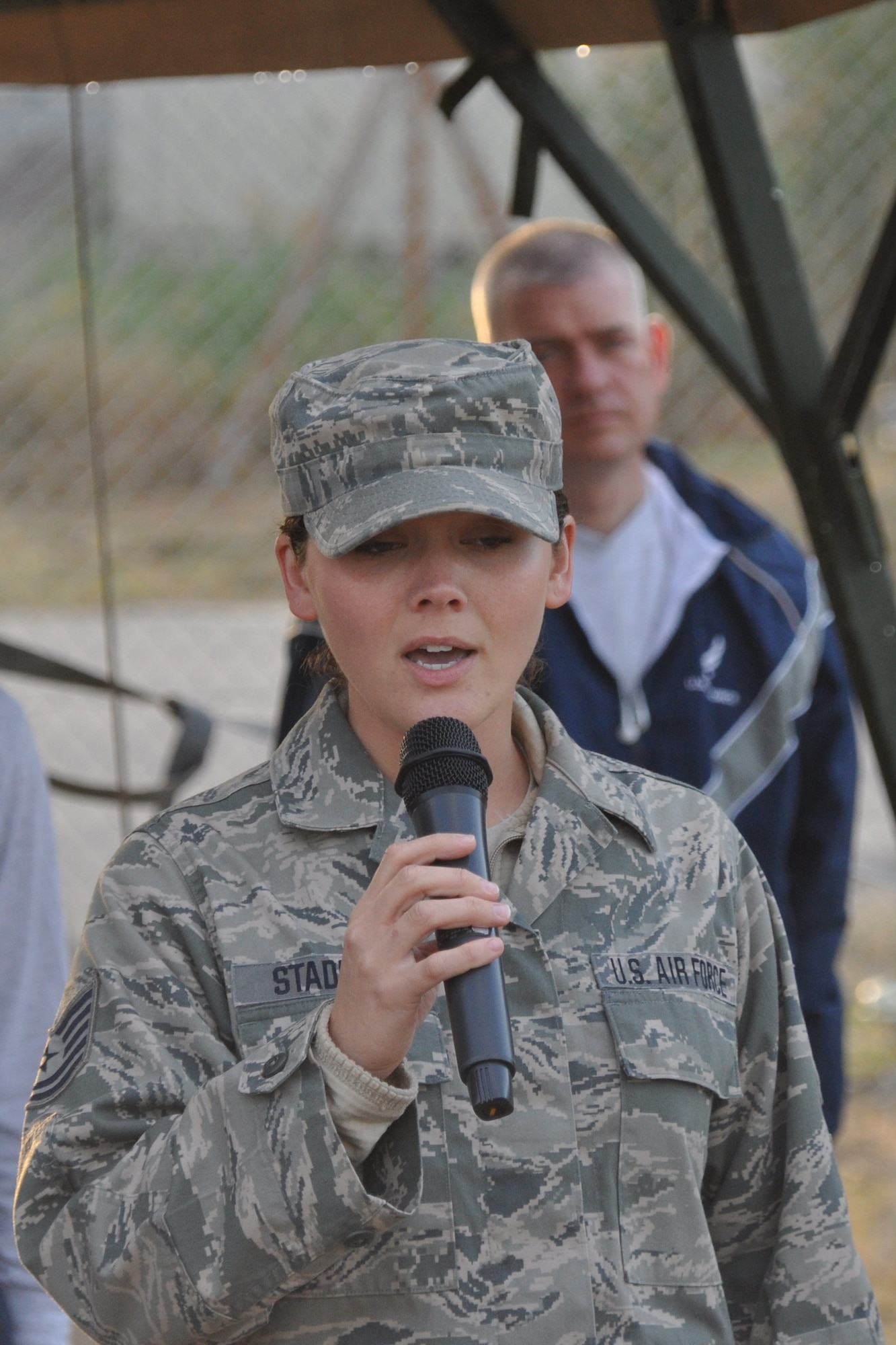 Tech. Sgt. Rebecca Stadler sings the National Anthem before the start of the Air Force Deployed Location 10k, Half, and Full Marathons at the Transit Center at Manas, Kyrgyzstan, Sept. 17. Stadler is assigned to the 376th Expeditionary Force Support Squadron as the NCO in charge of the fitness center. She is deployed here from the Air National Guard's 179th Airlift Wing in Mansfield, Ohio. (U.S. Air Force photo/Staff Sgt. Brianne Smith)