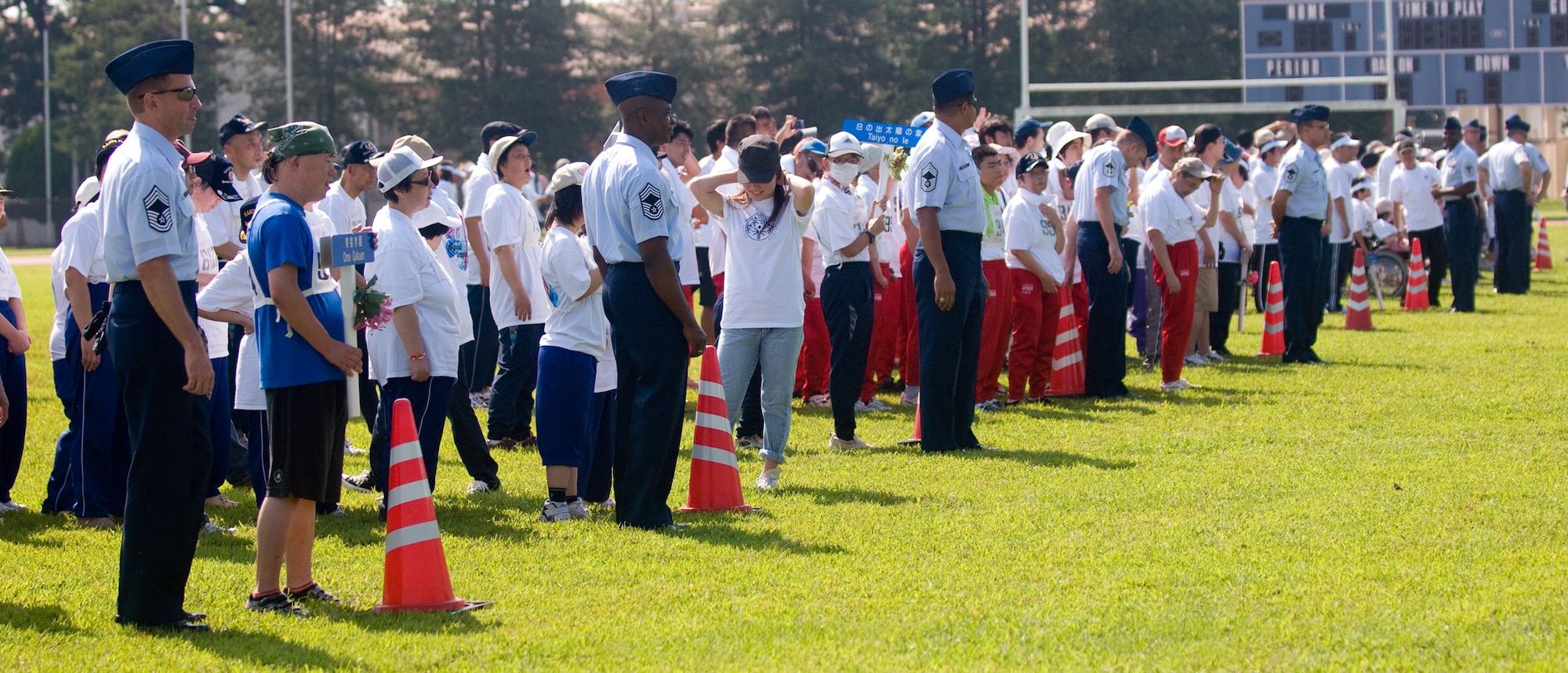 YOKOTA AIR BASE, Japan -- Athletes line up on the field behind Yokota's Chiefs at the Special Olympics at Yokota Air Base, Japan, Sept. 10, 2011. Each Chief walked along with a participating school. (U.S. Air Force photo/Airman 1st Class Krystal M. Garrett)