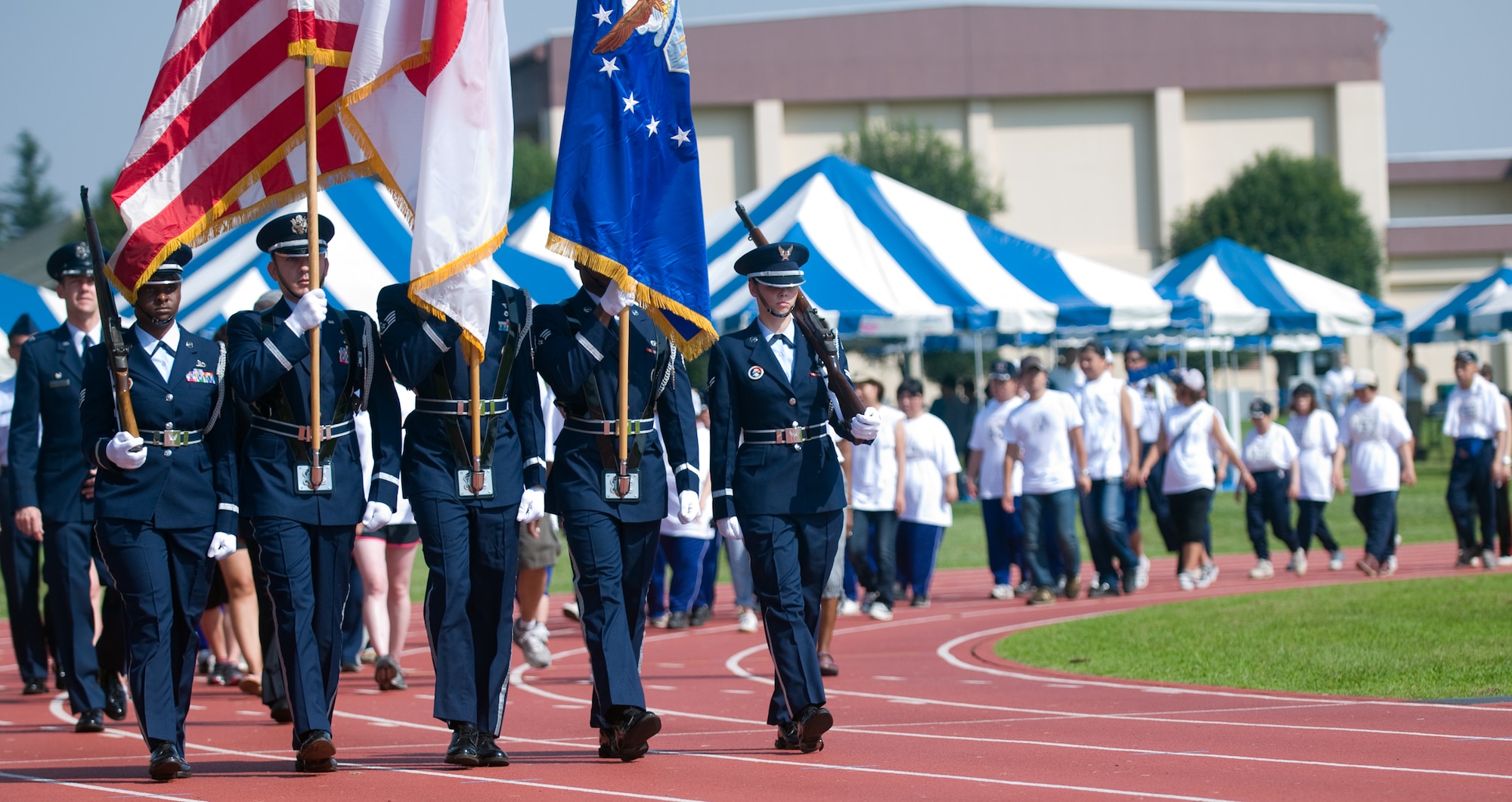 YOKOTA AIR BASE, Japan -- Yokota's Honor Guard lead the Parade of Hope march around the Yokota High School track during the 2011 Special Olympics at Yokota Air Base, Japan, Sept. 10, 2011. The honor guard was followed by the 224 athletes at this year's competition. (U.S. Air Force photo/Airman 1st Class Krystal M. Garrett)